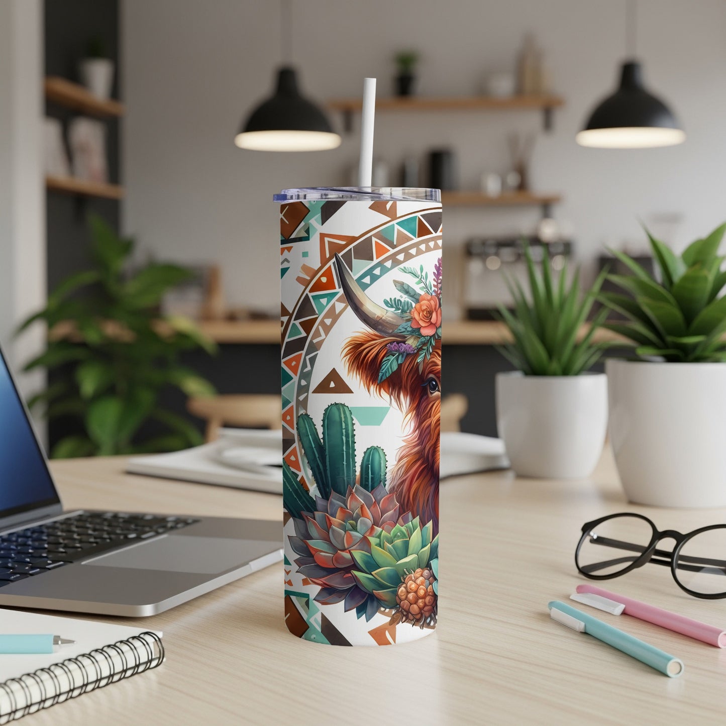 Highland cow with floral and cactus pattern on a white tumbler.