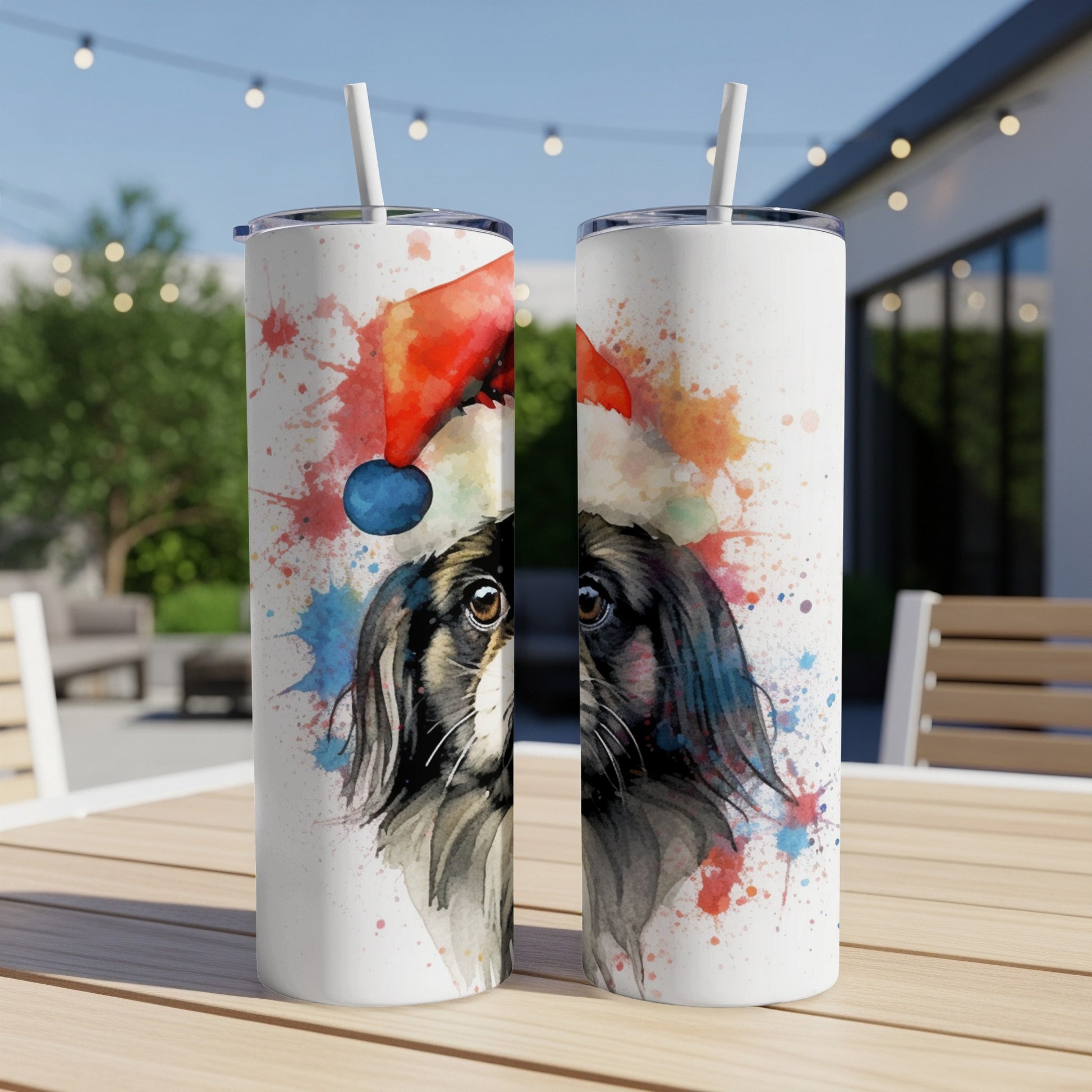 Two tumblers with a watercolor dog wearing a Santa hat design.