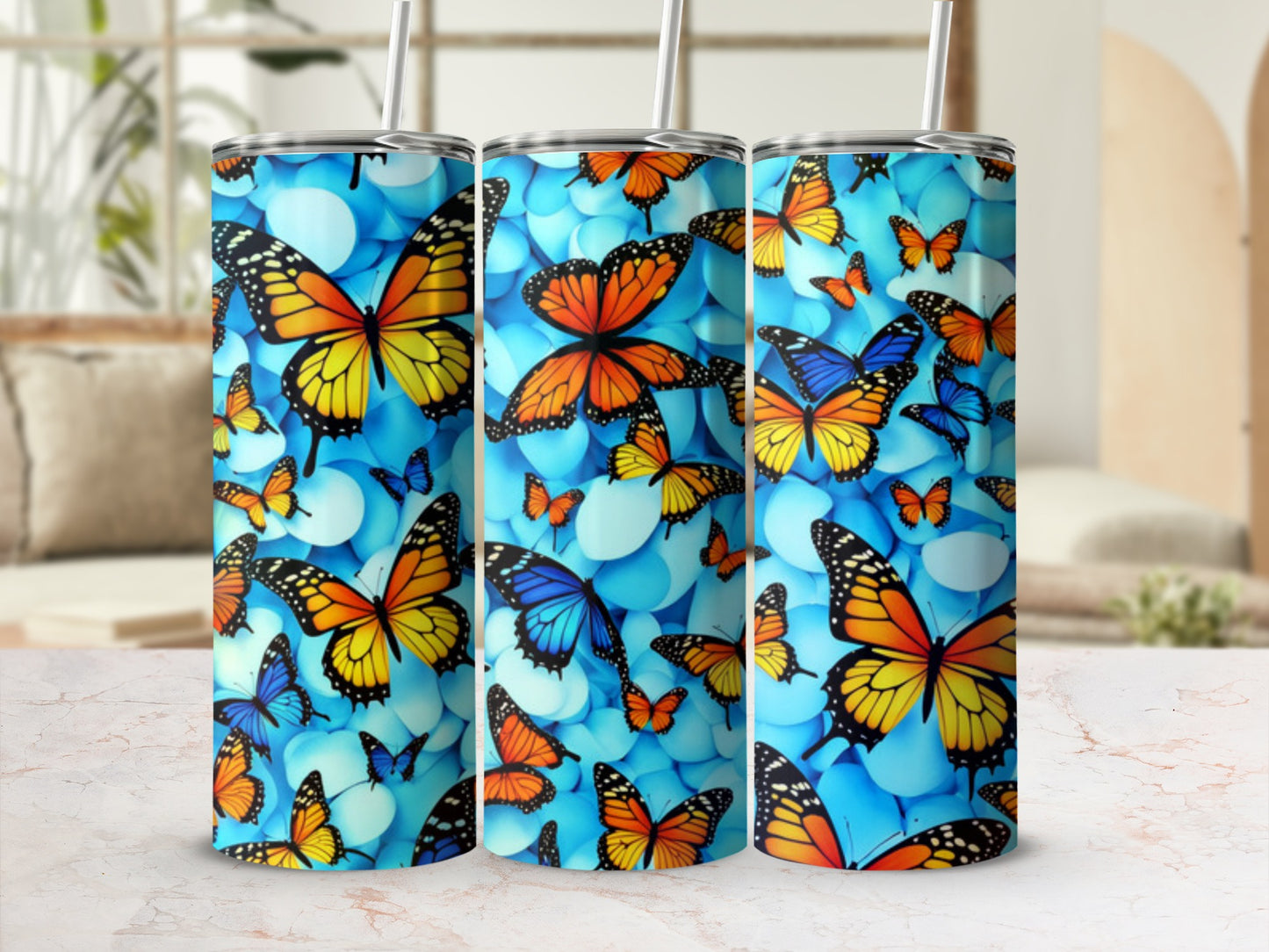 Tall tumbler with a blue background and colorful monarch butterflies.