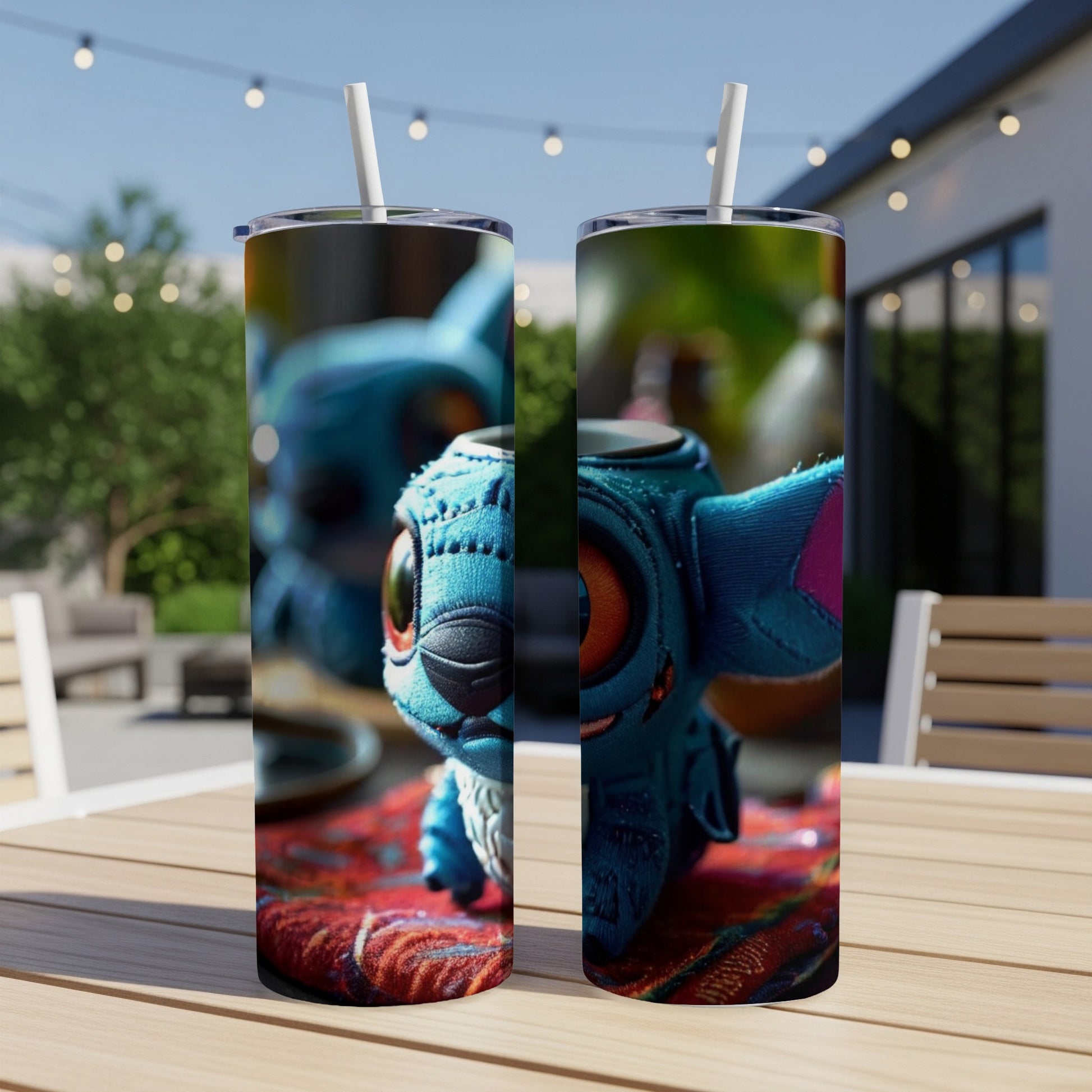 Stitch character on two skinny tumblers on a table outdoors.
