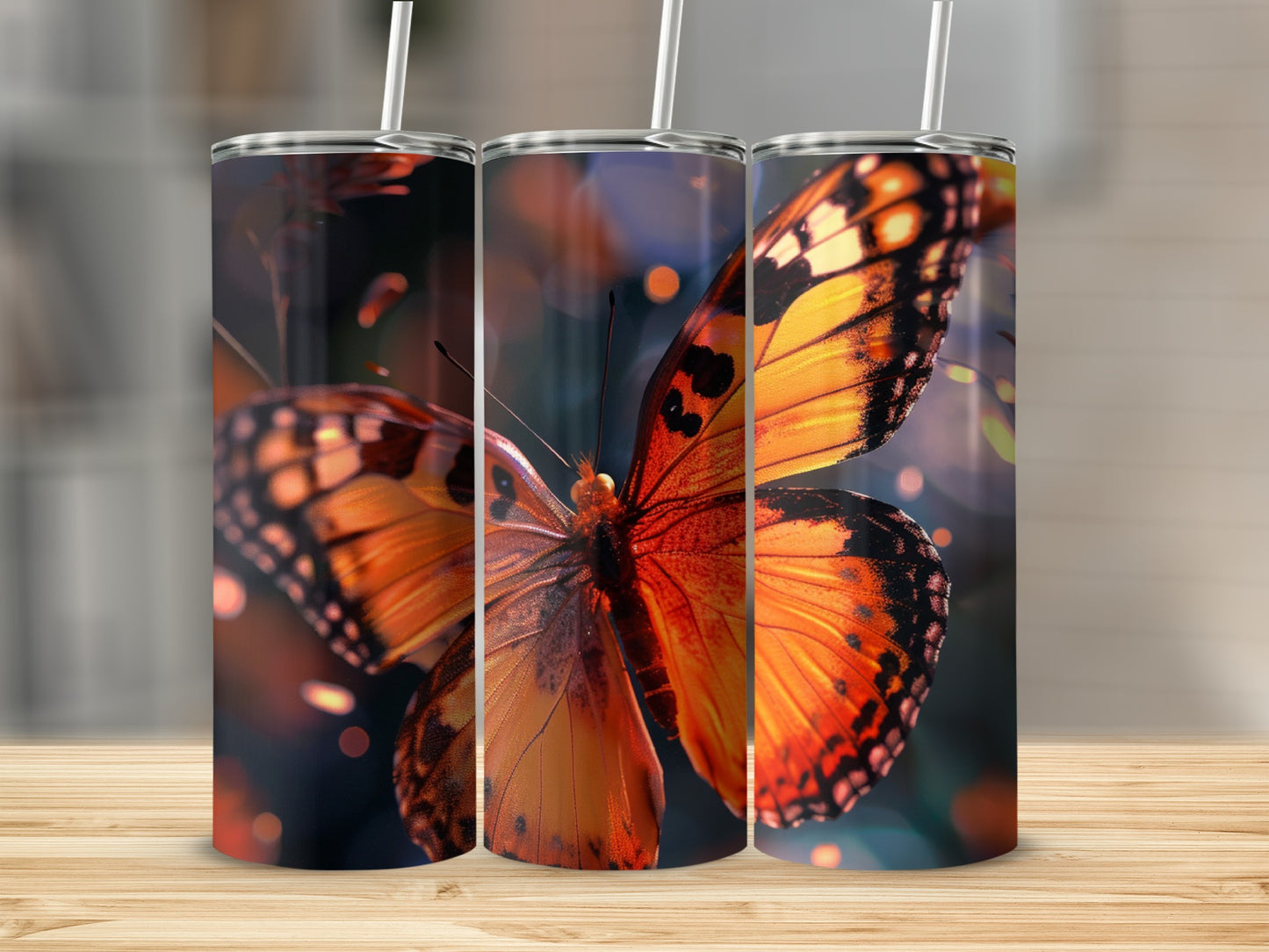 Three tumblers featuring a close-up of an orange butterfly with bokeh background.
