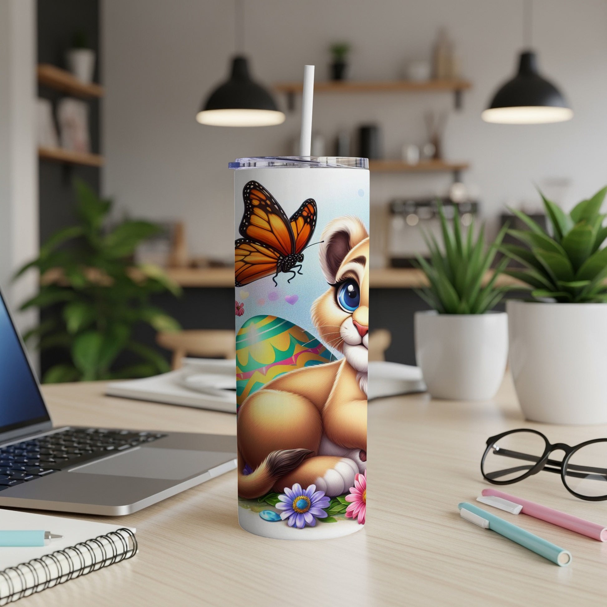 Cartoon lion cub with butterfly and Easter eggs on a tumbler.