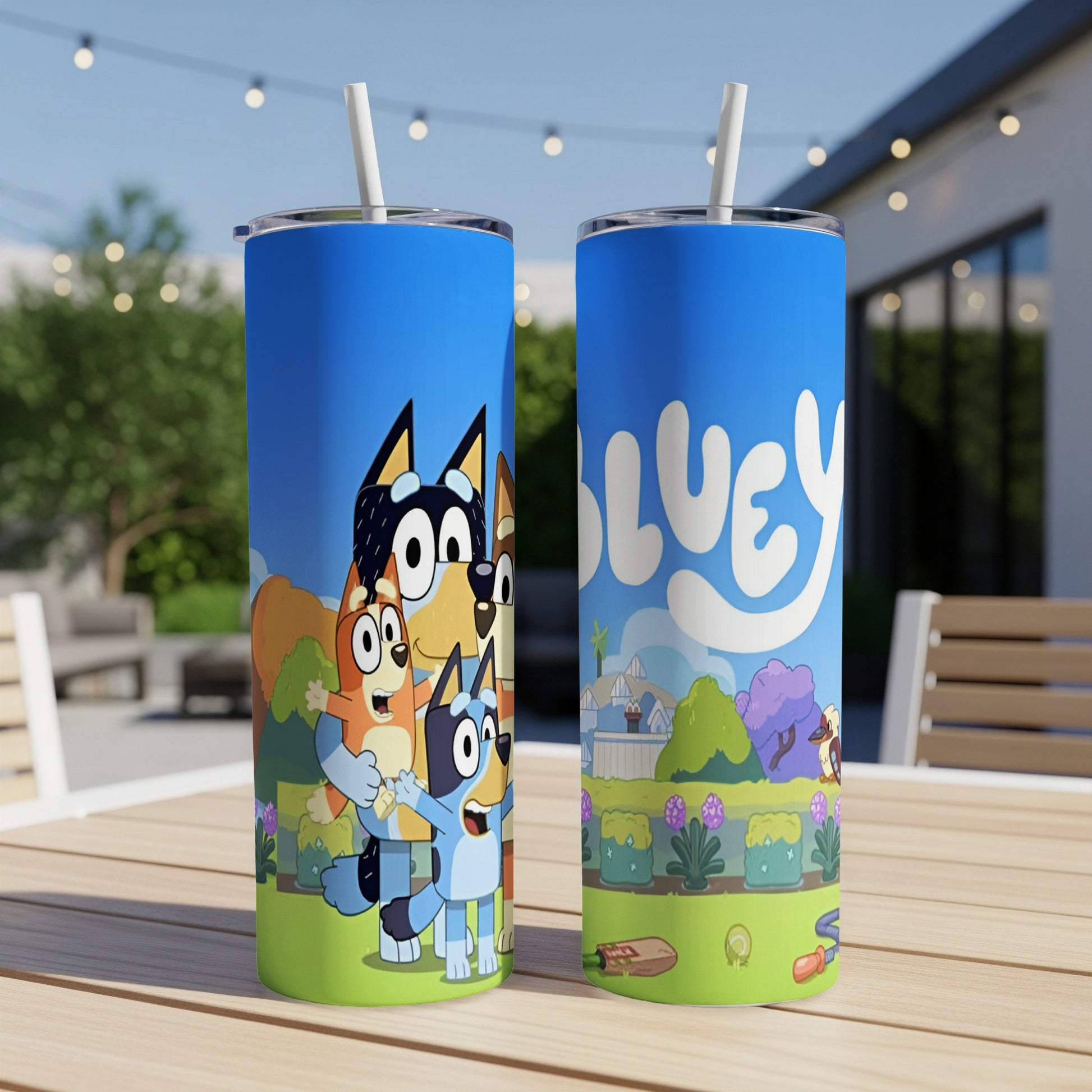 Bluey character tumbler with straw, featuring cartoon dogs and trees.