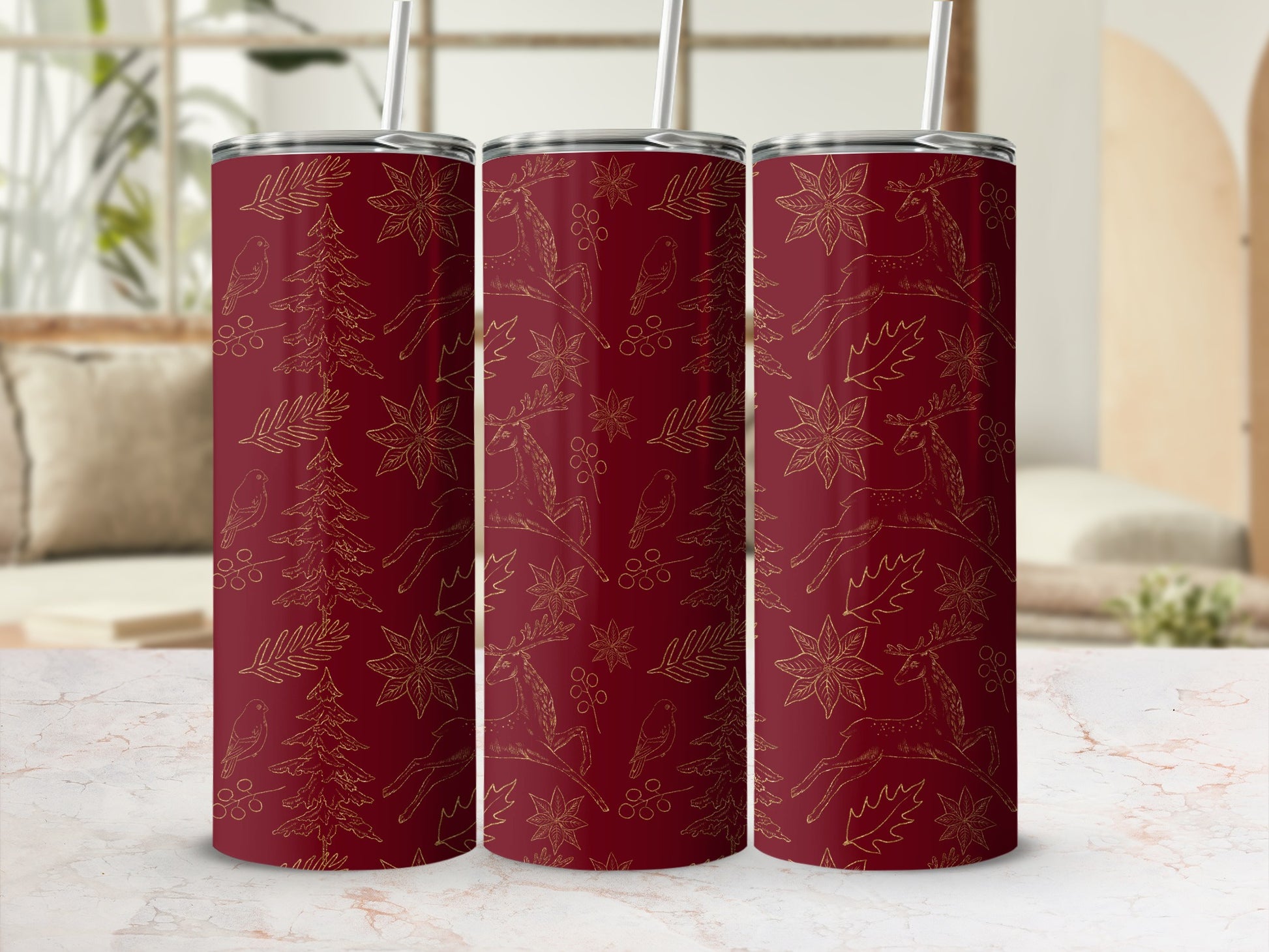 Three ruby red tumblers with a gold pattern of deer and pine trees.