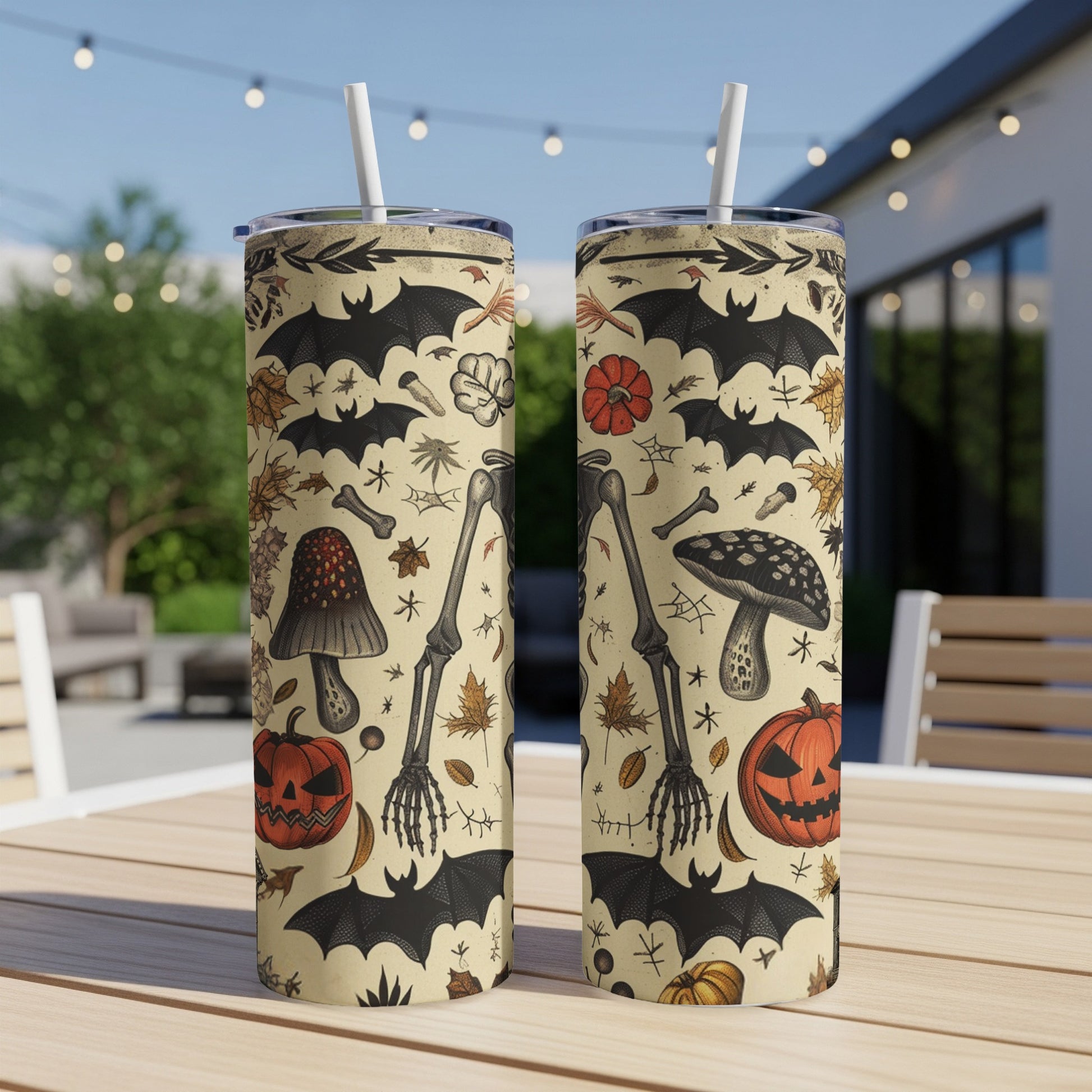 Halloween themed tumblers with bats, skeletons, pumpkins, mushrooms, and leaves.