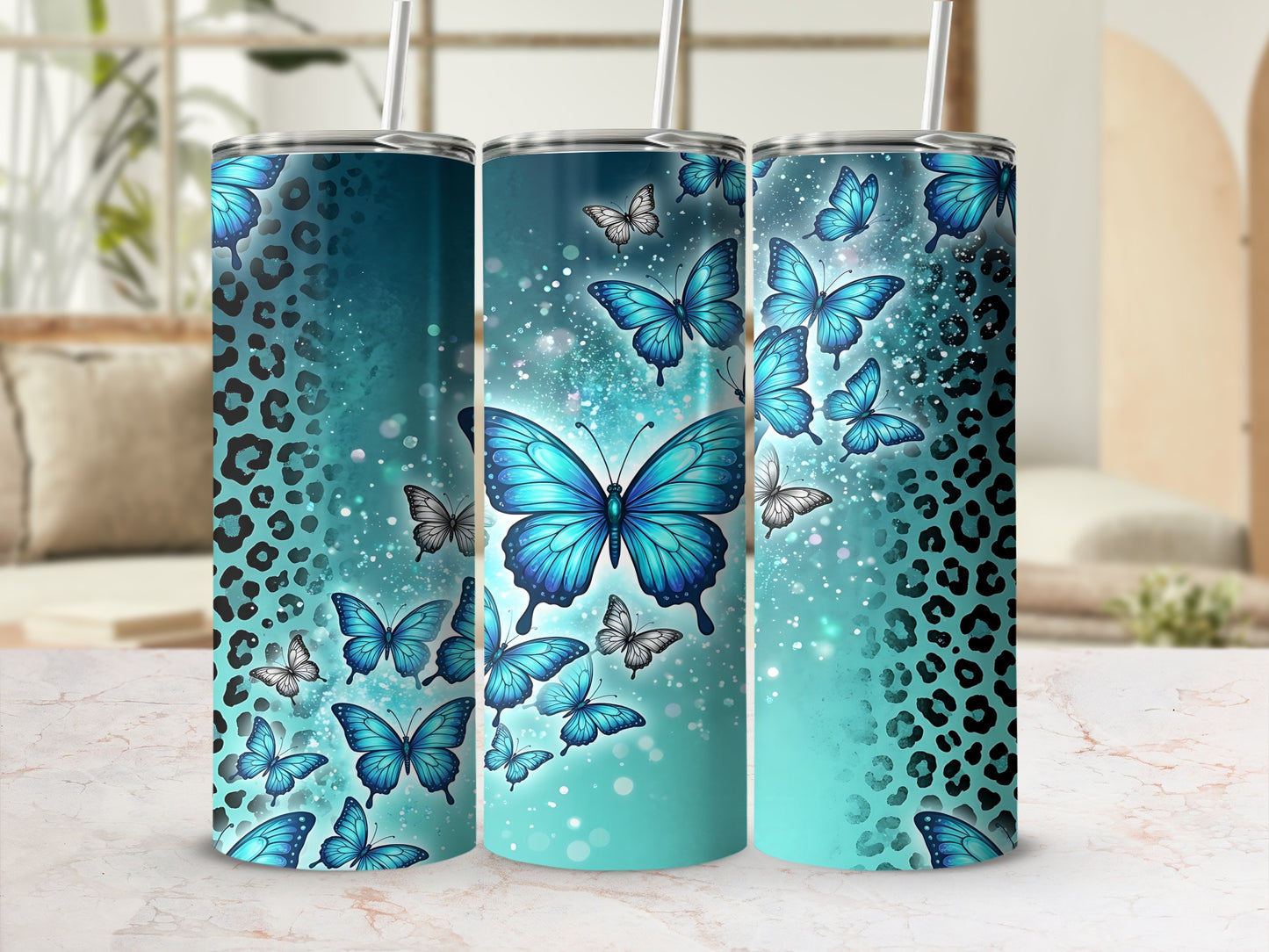 Three turquoise tumblers with blue butterflies and leopard print details.