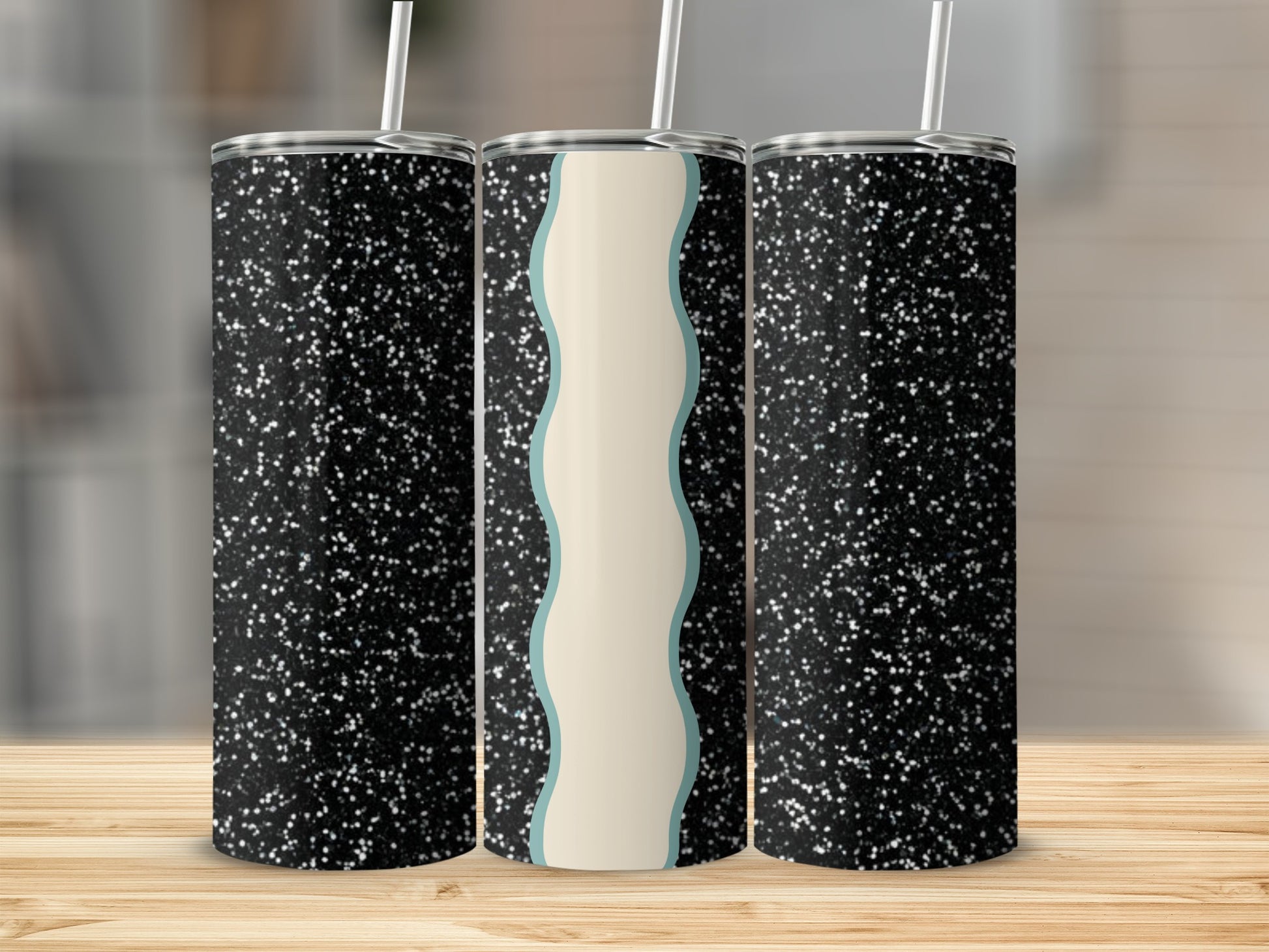 Three glitter tumblers with wavy cream and blue stripe design.