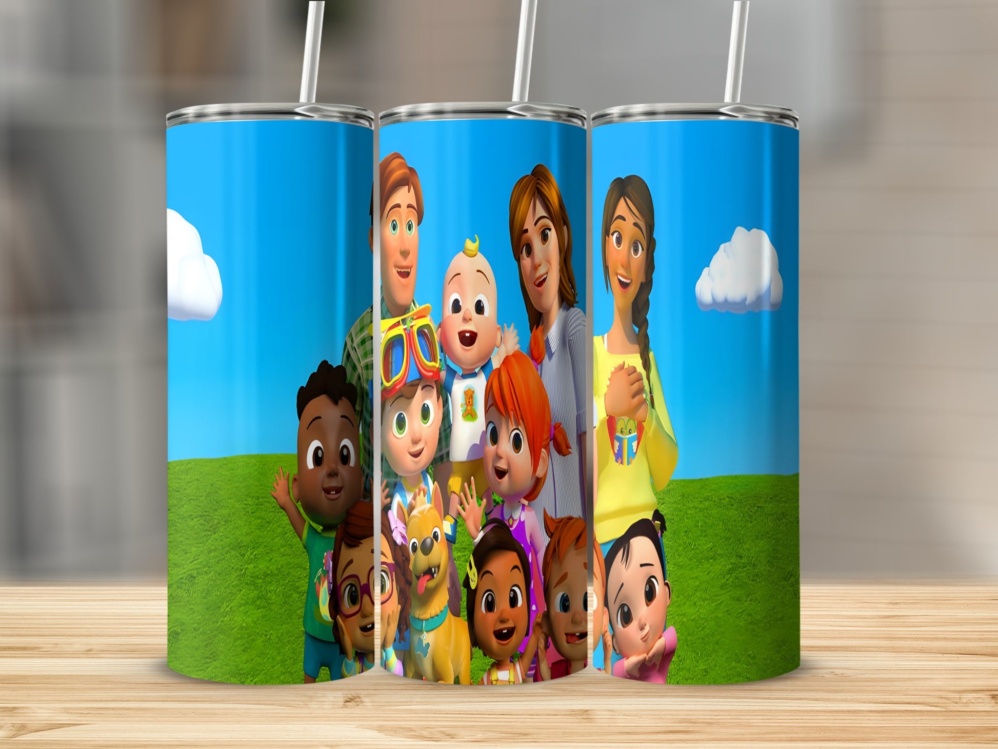 Cocomelon characters on a tumbler with a grassy background and blue sky.