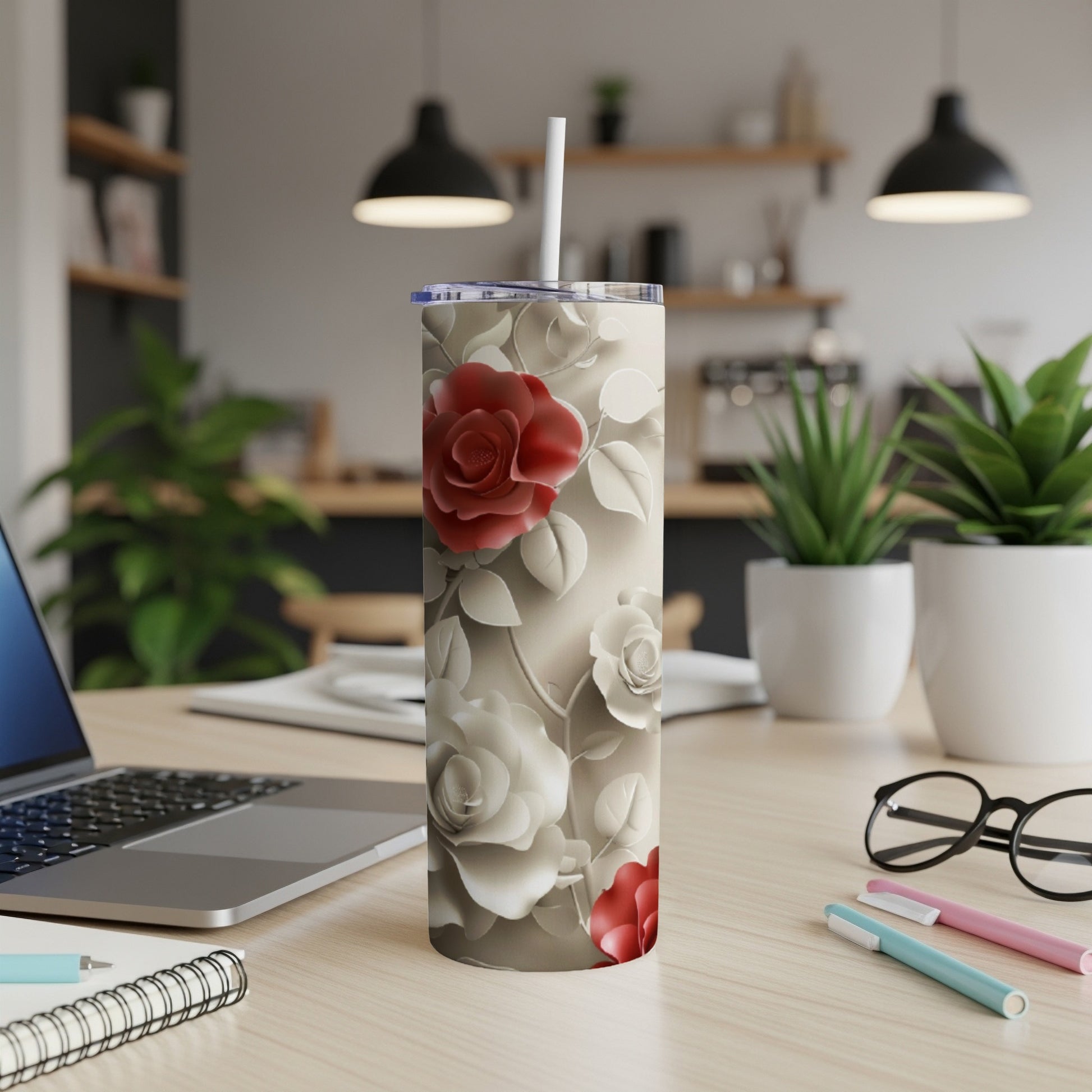 White tumbler with red roses and beige floral pattern, straw inserted.