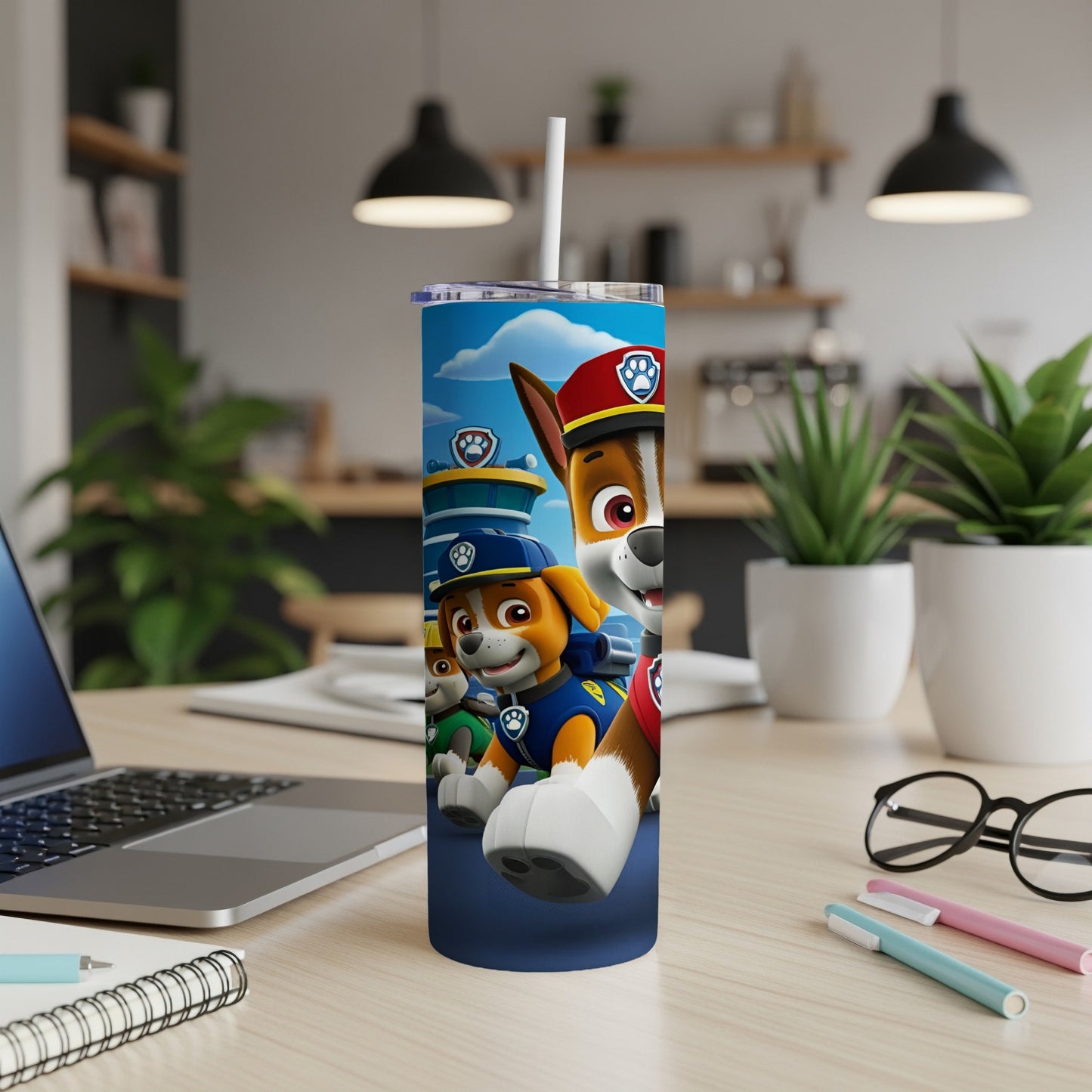Paw Patrol characters on a blue tumbler with a straw.