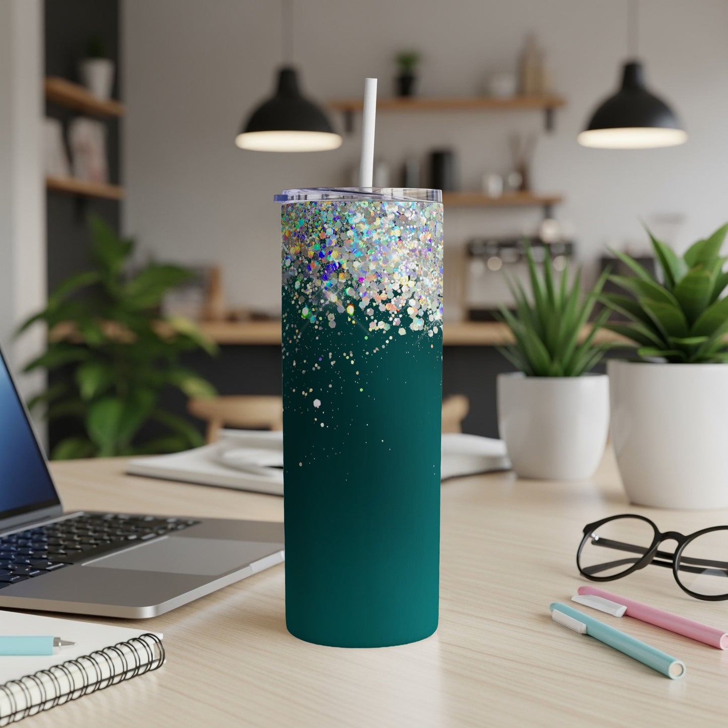 Teal tumbler with scattered holographic glitter and white straw.