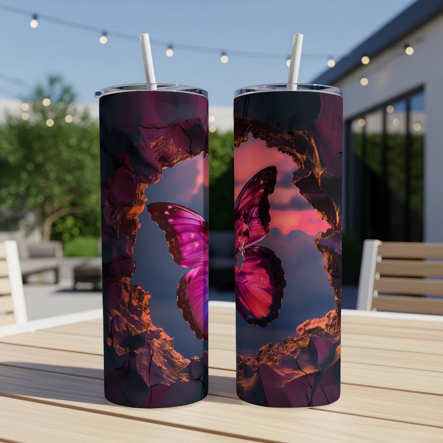 Two tumblers with a vibrant pink butterfly against a rocky sunset backdrop.