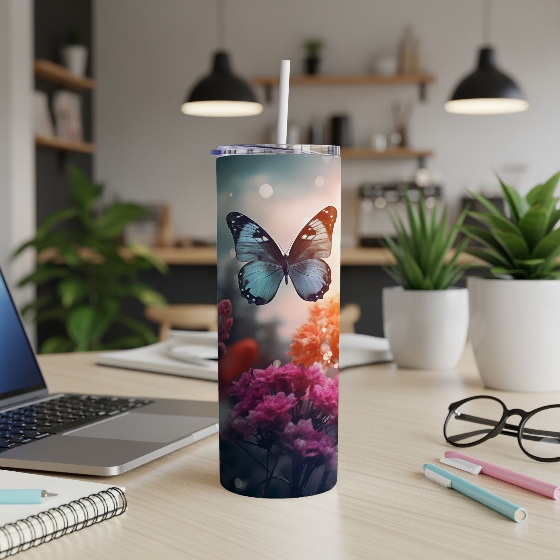 Blue butterfly above colorful flowers on a decorated tumbler.