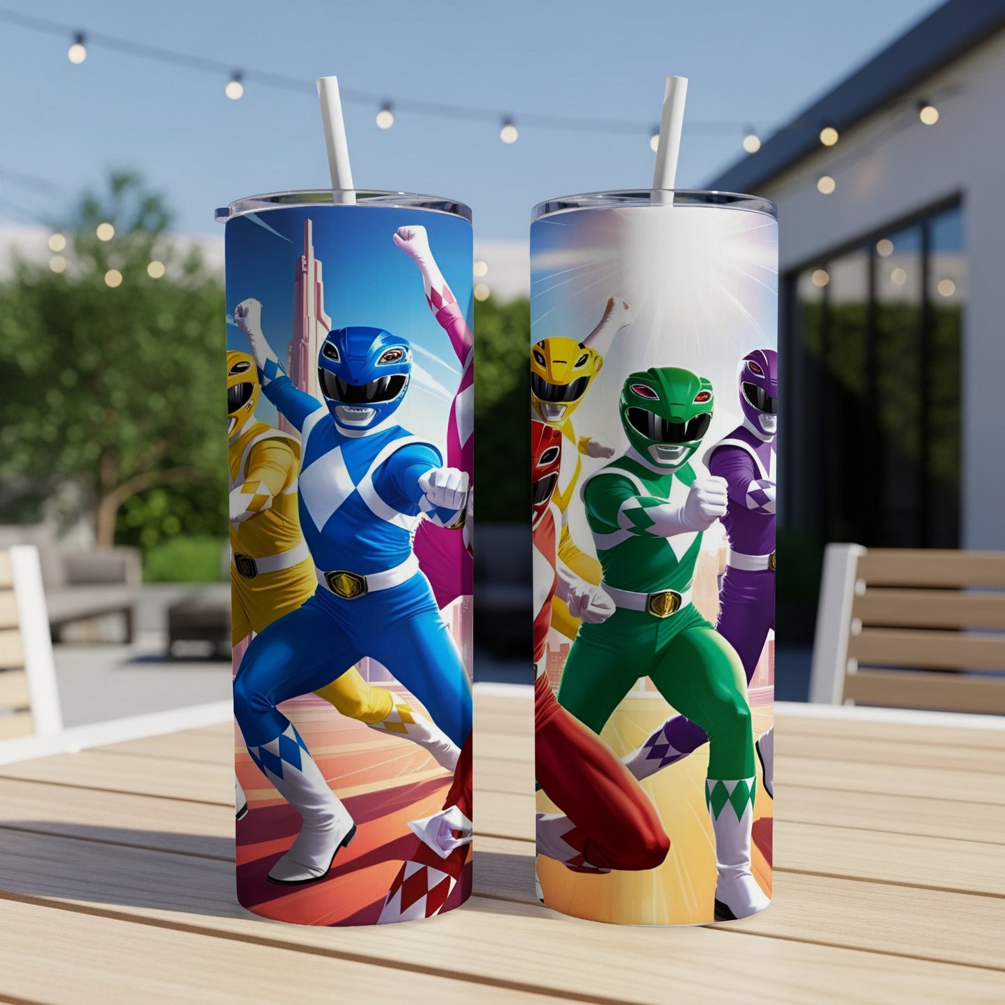 Two tall tumblers featuring the Power Rangers in action poses on a patio table.