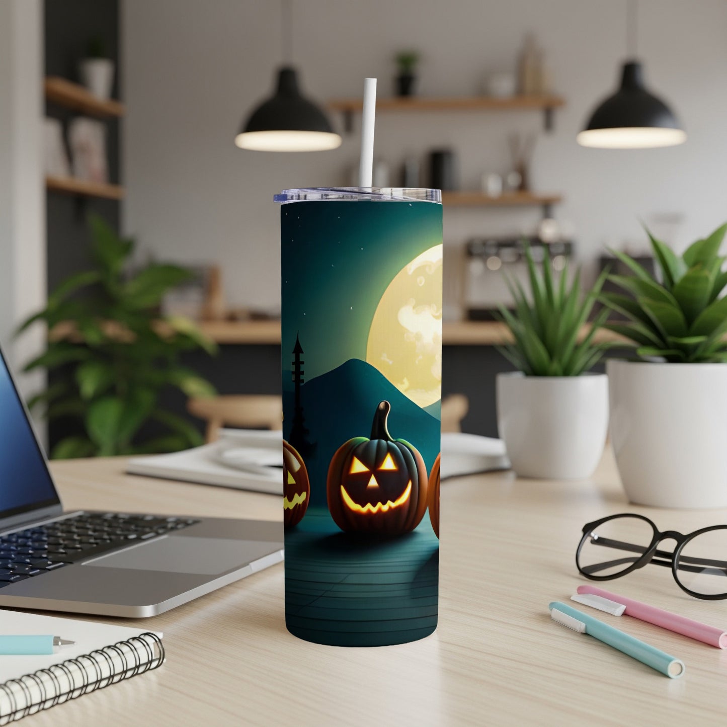 Tumbler with jack-o'-lanterns, moon, and spooky landscape design.