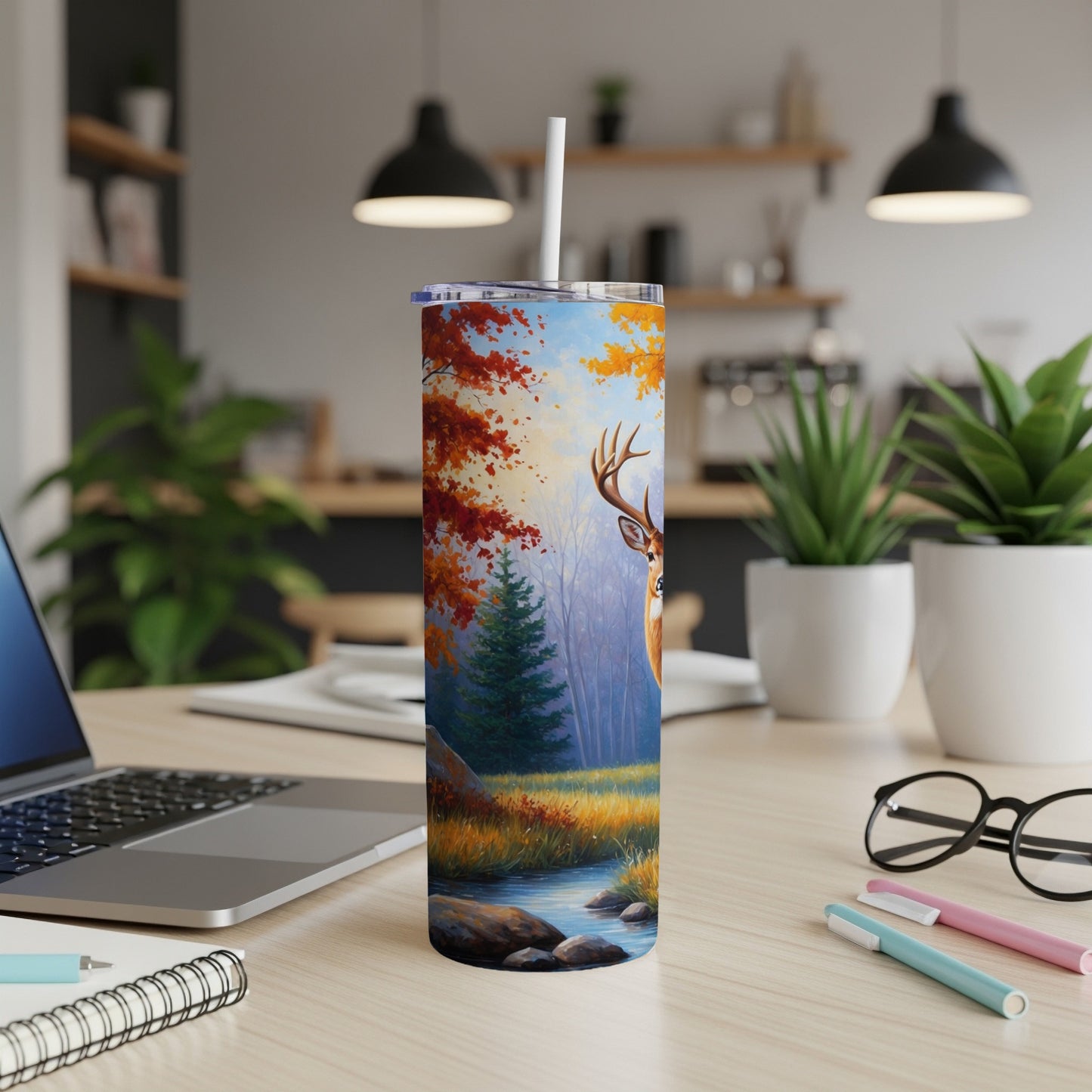 Deer by stream with autumn trees on a tumbler.