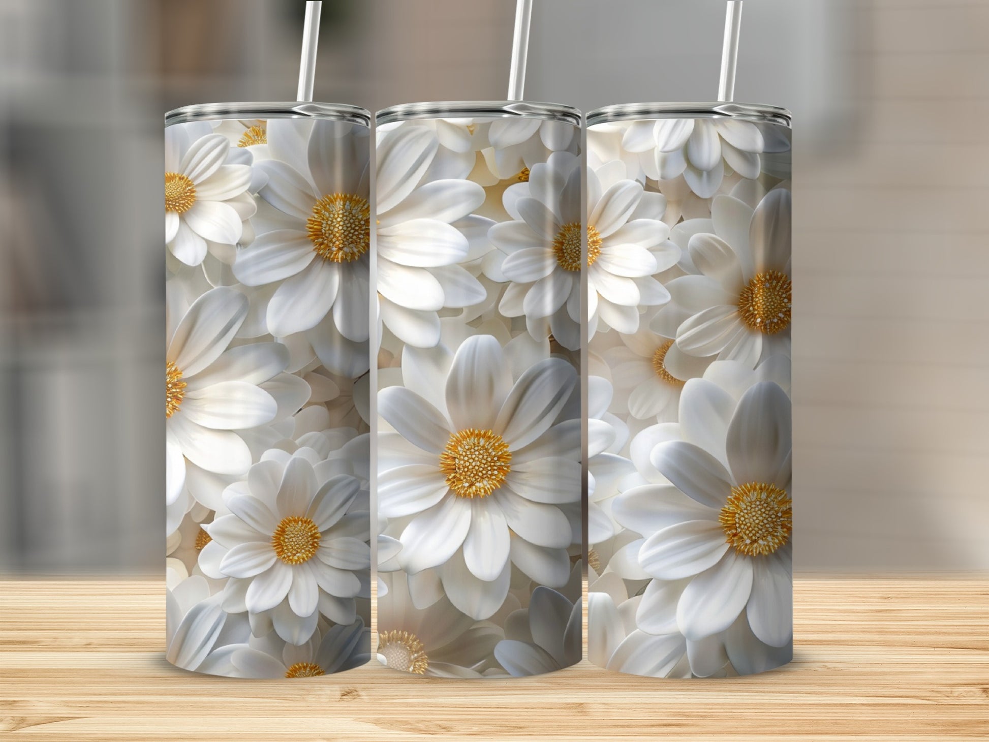 Three white daisy tumblers with straws on a wooden surface.