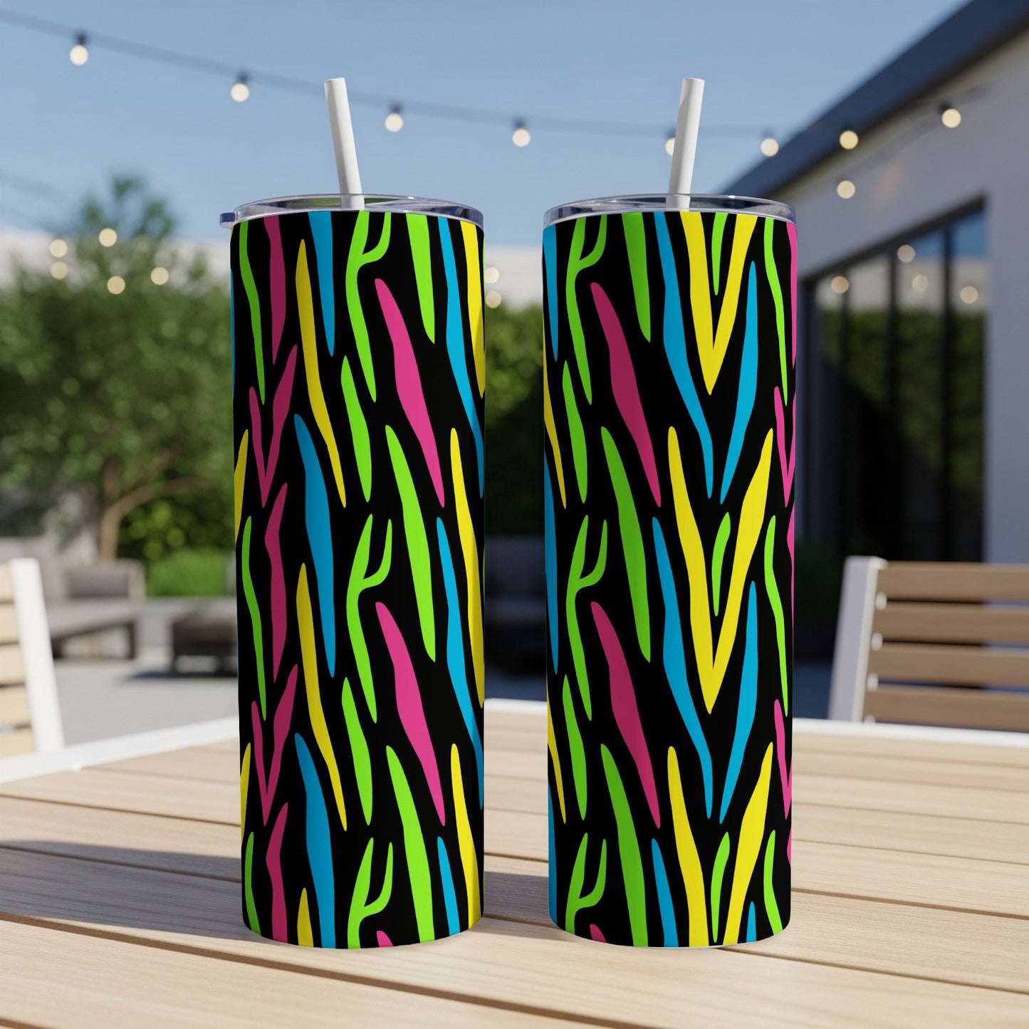 Two tumblers with a neon zebra stripe pattern on a wooden table.