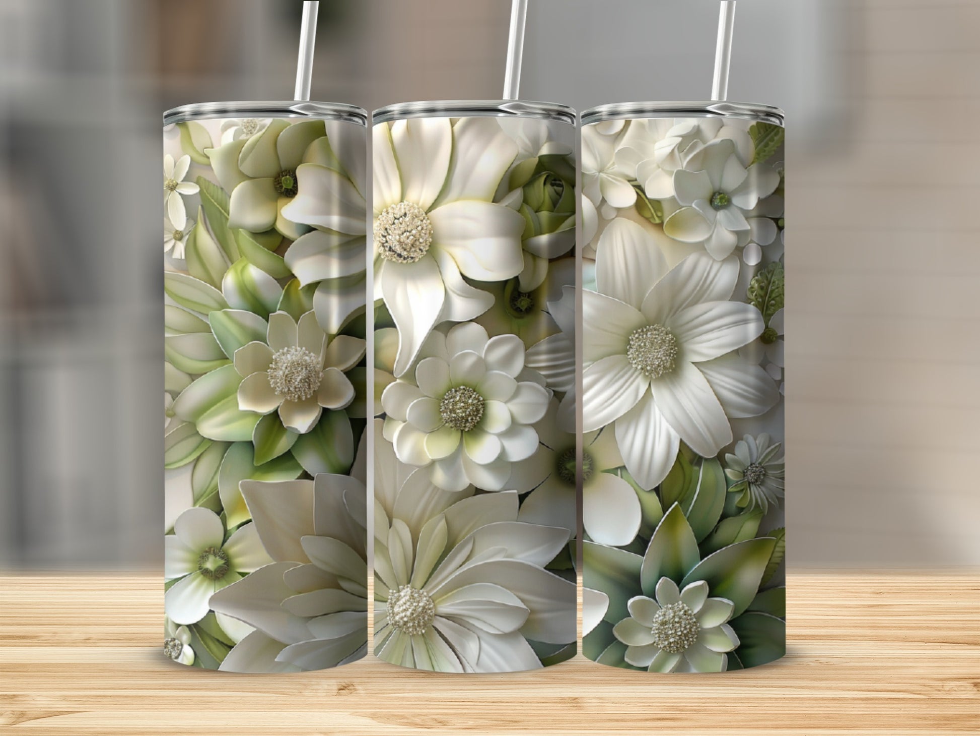 Three tumblers decorated with white and green floral designs.