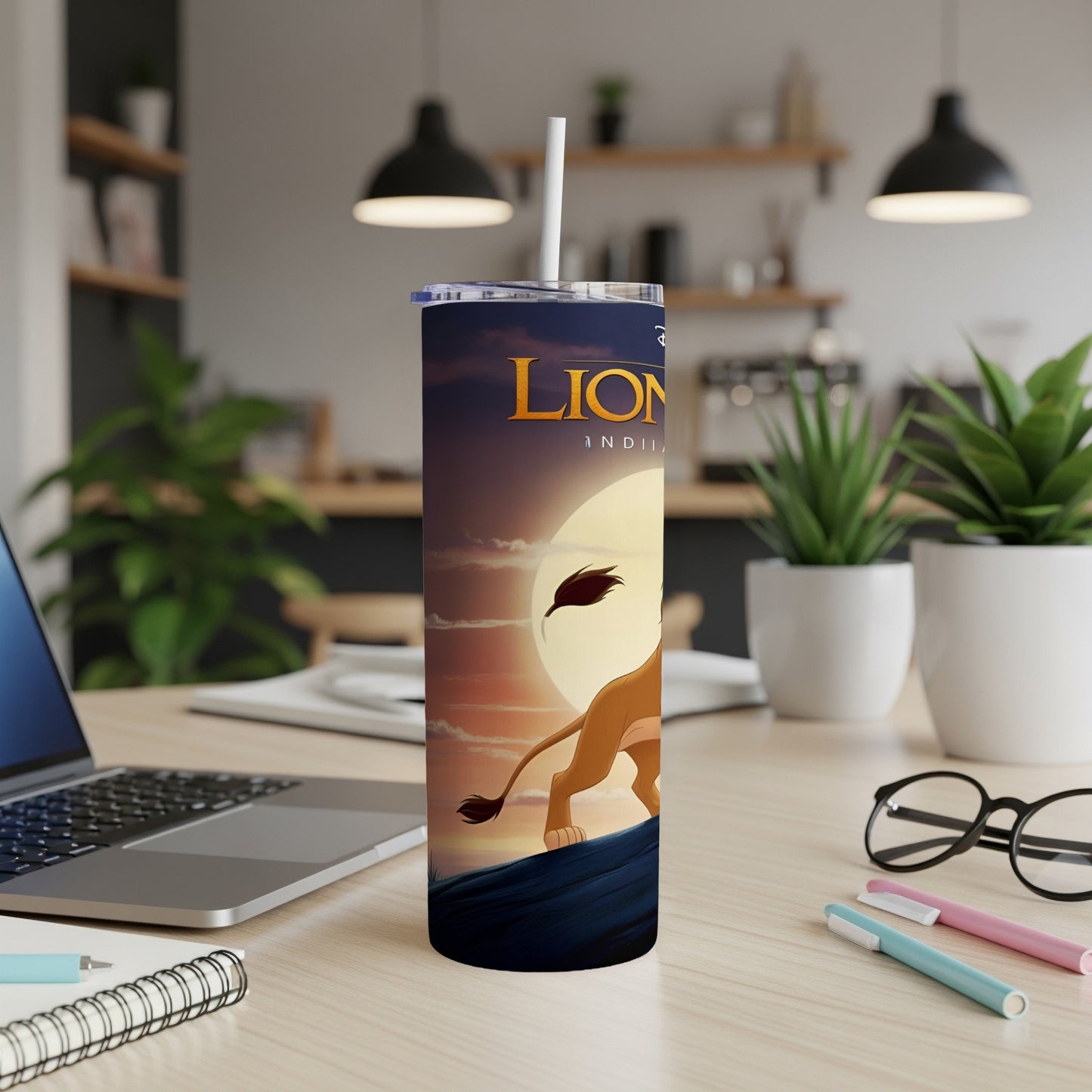 The Lion King tumbler with a lion silhouette against a sunset.