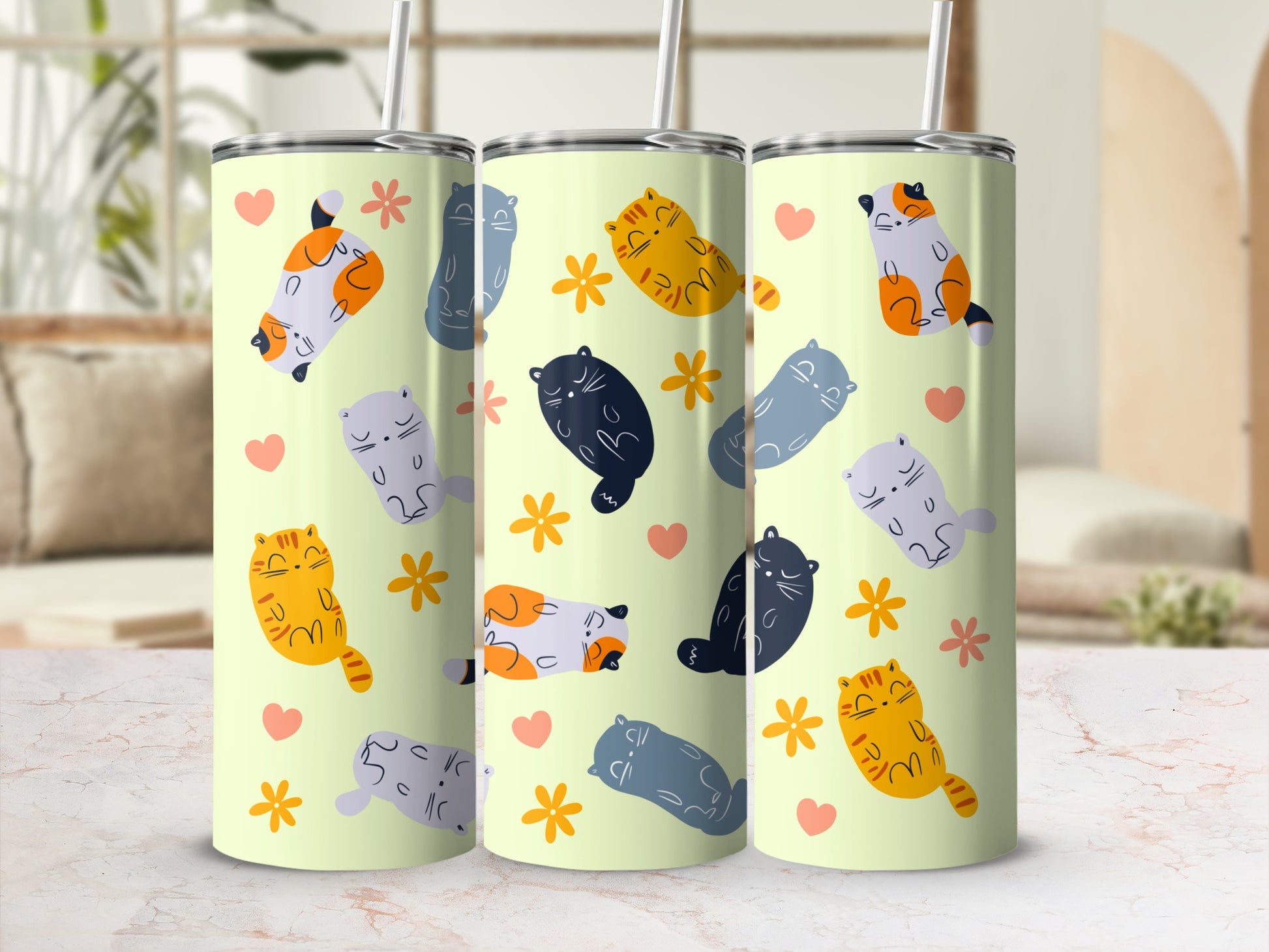 Three tumblers with light yellow background featuring cartoon cats and flowers.