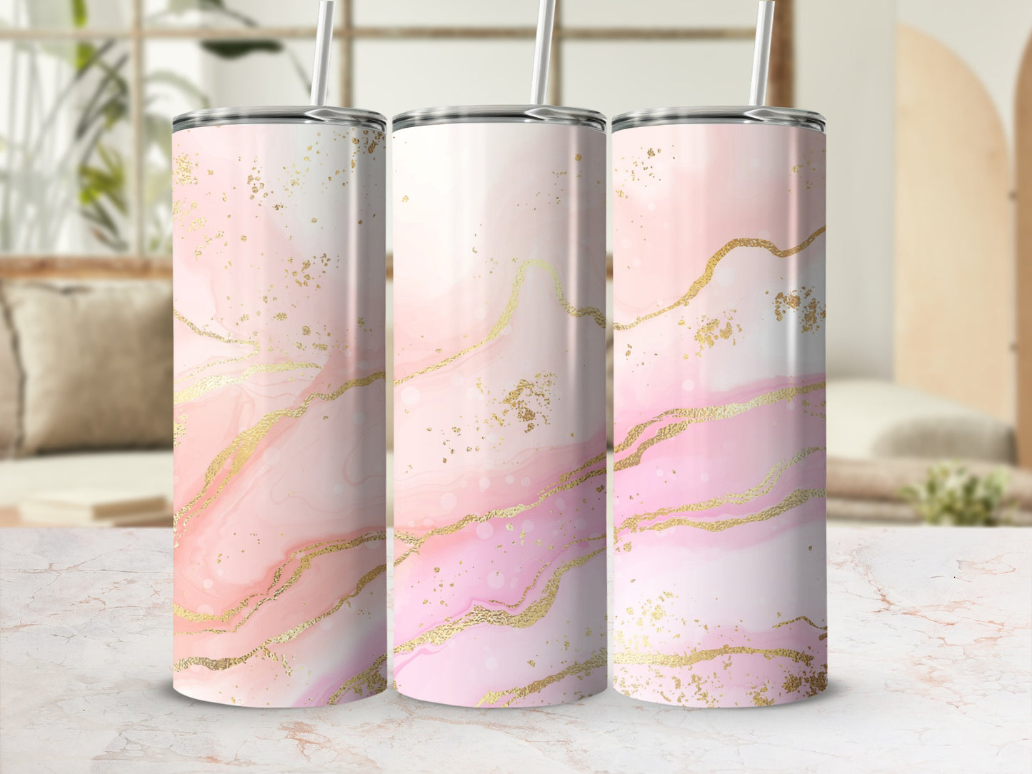 Three tall tumblers with pink and gold marbled design and straws.