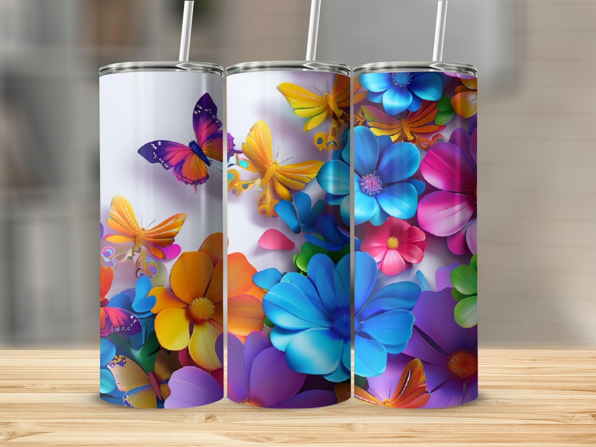 Three tumblers with colorful butterflies and flowers design.