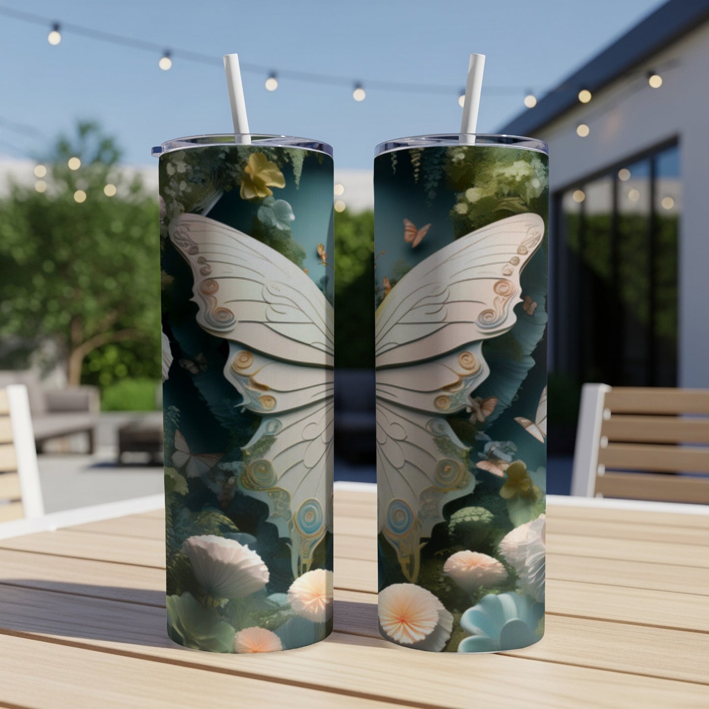 Two tumblers with intricate butterfly wing designs on a wooden table.