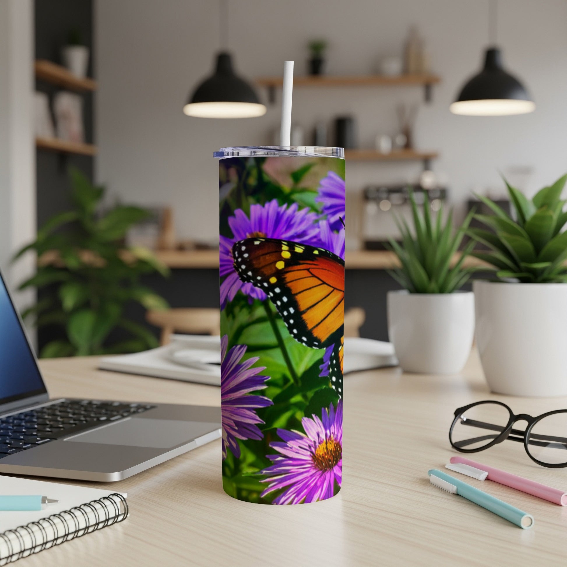 Monarch butterfly on purple flowers on a tumbler.