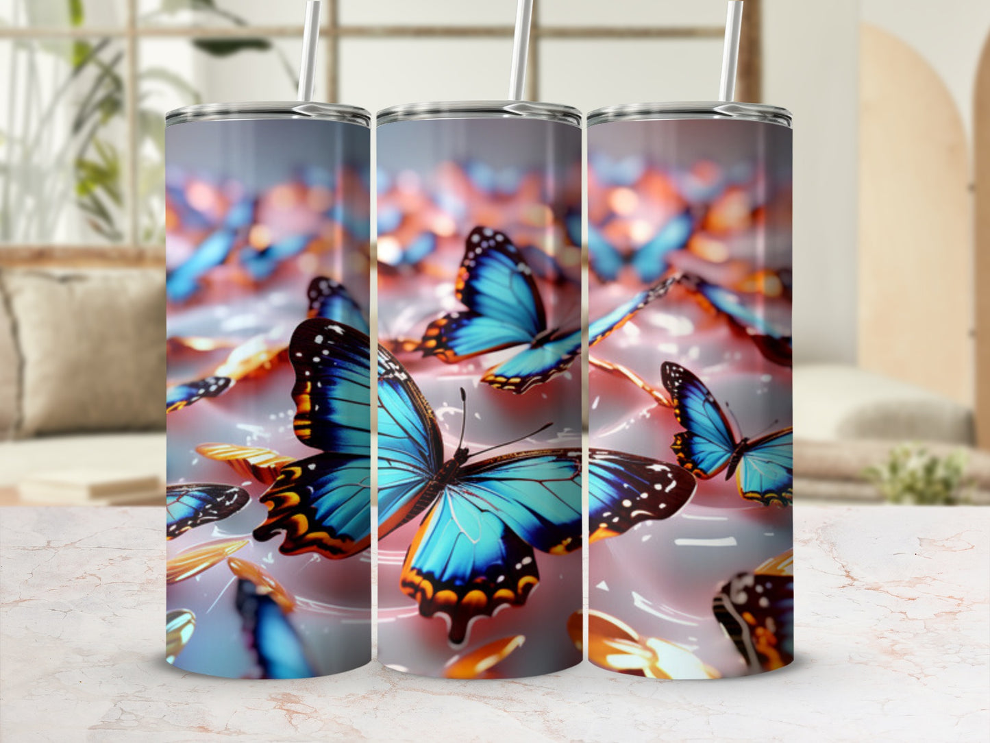 Three tumblers with blue butterflies and gold accents.