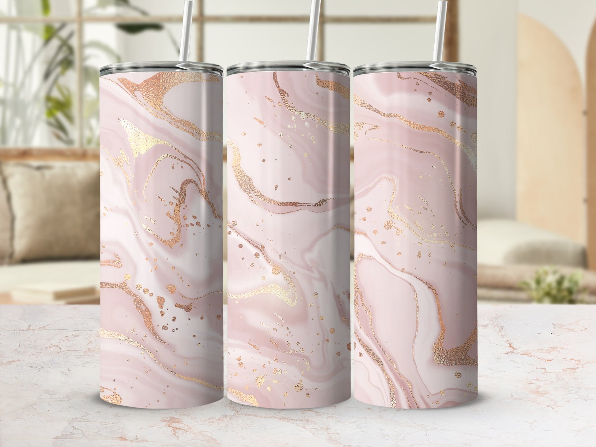 Three rose gold and white marble pattern tumblers with straws.