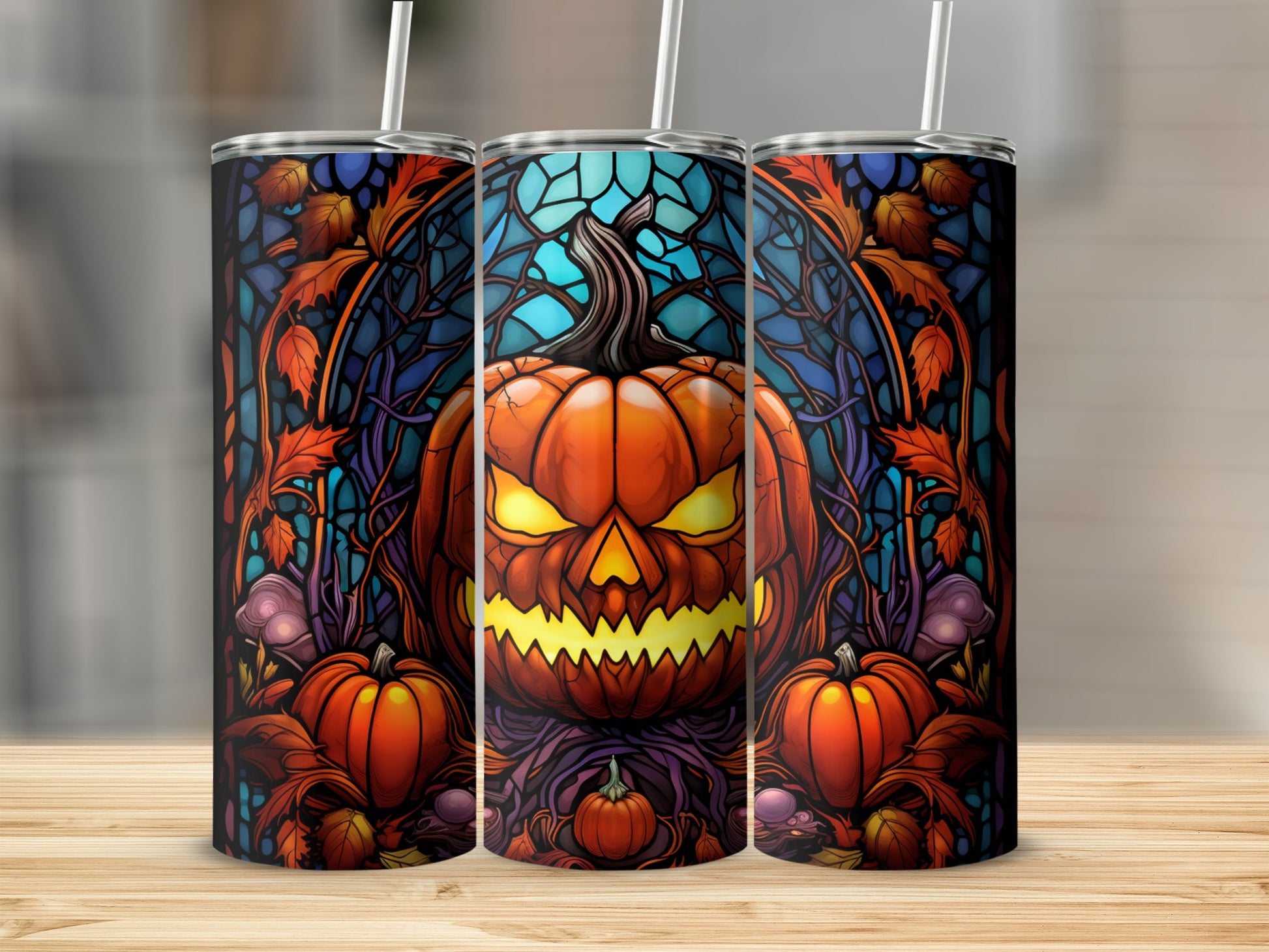 Three Halloween tumblers featuring a jack-o'-lantern and stained-glass style background.