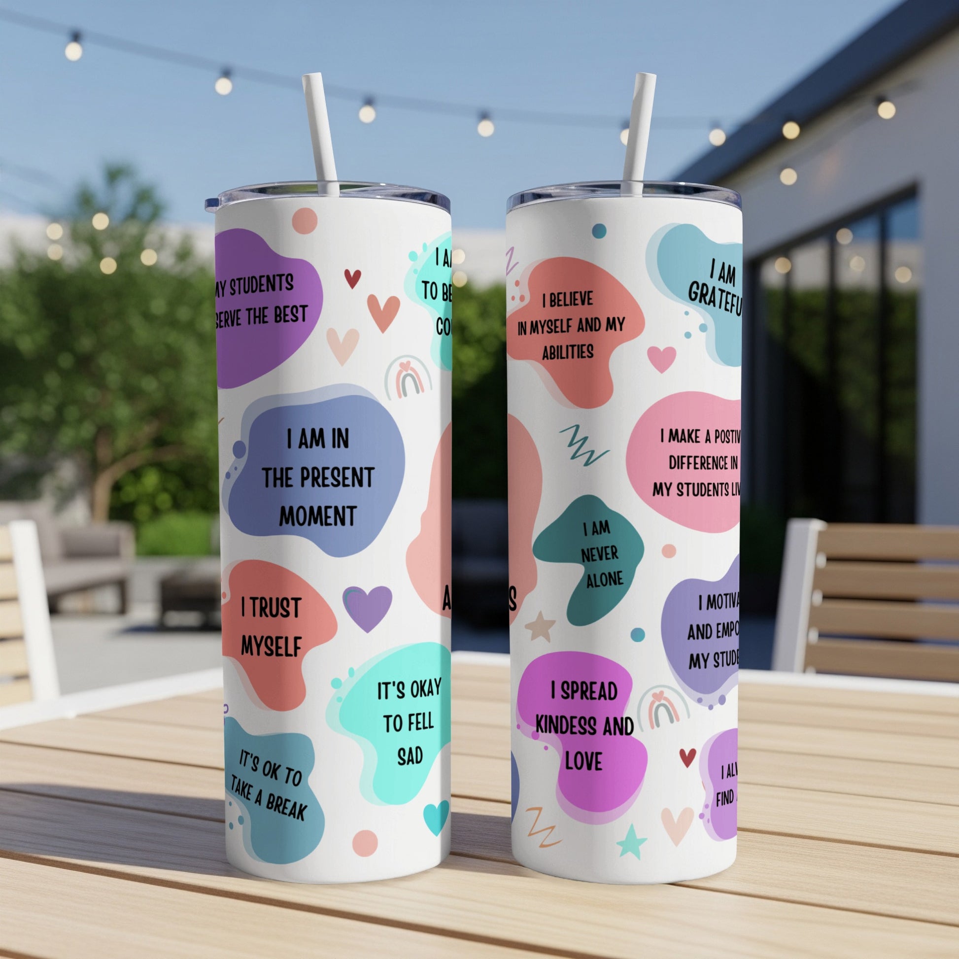 Two tumblers with inspirational quotes and colorful abstract designs.