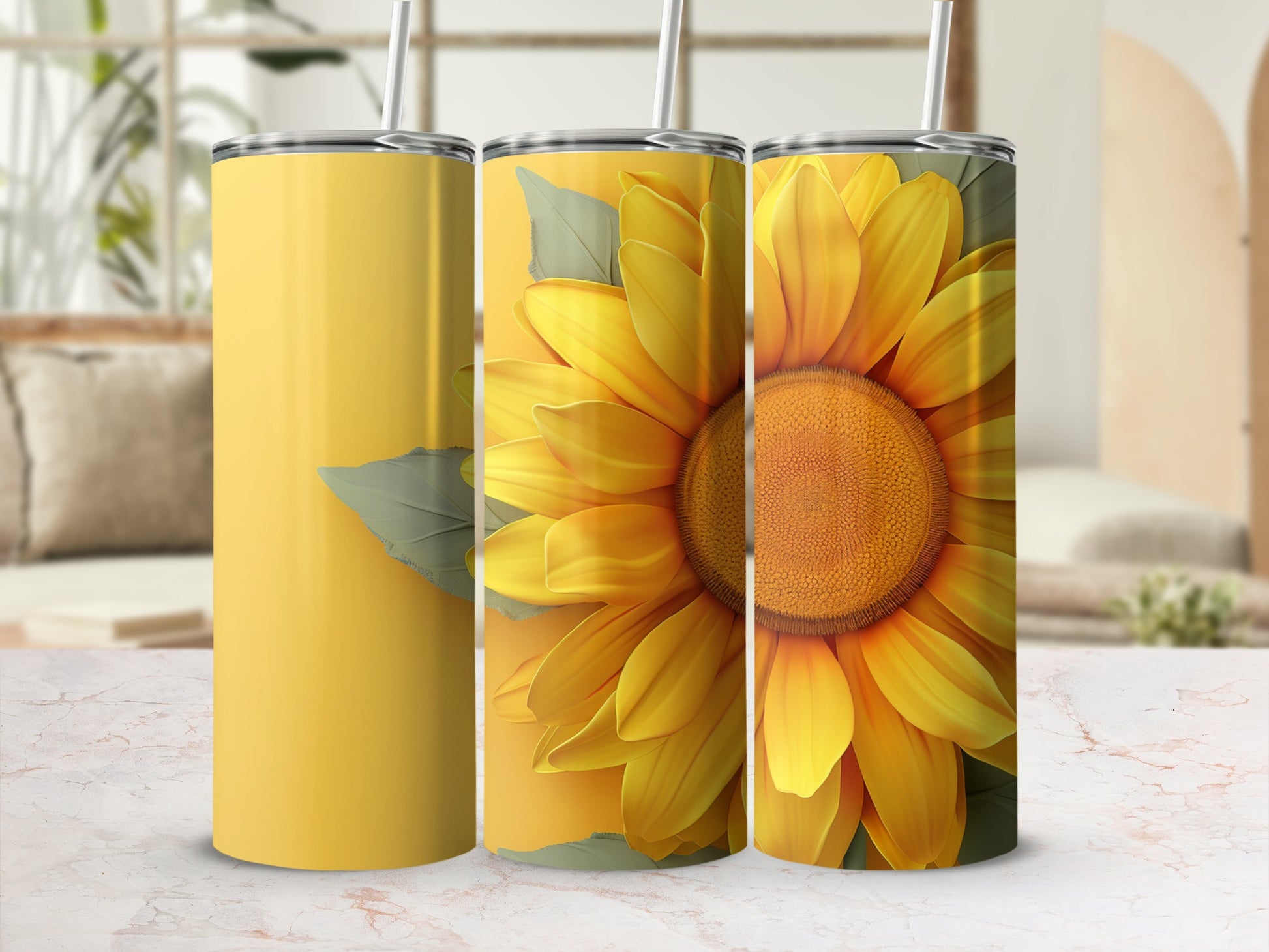 Three yellow tumblers, one with a sunflower design, on a table.