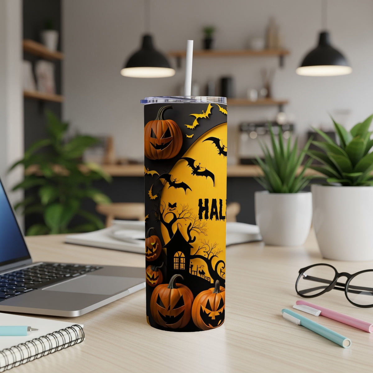 Halloween tumbler with pumpkins, bats, and haunted house design.