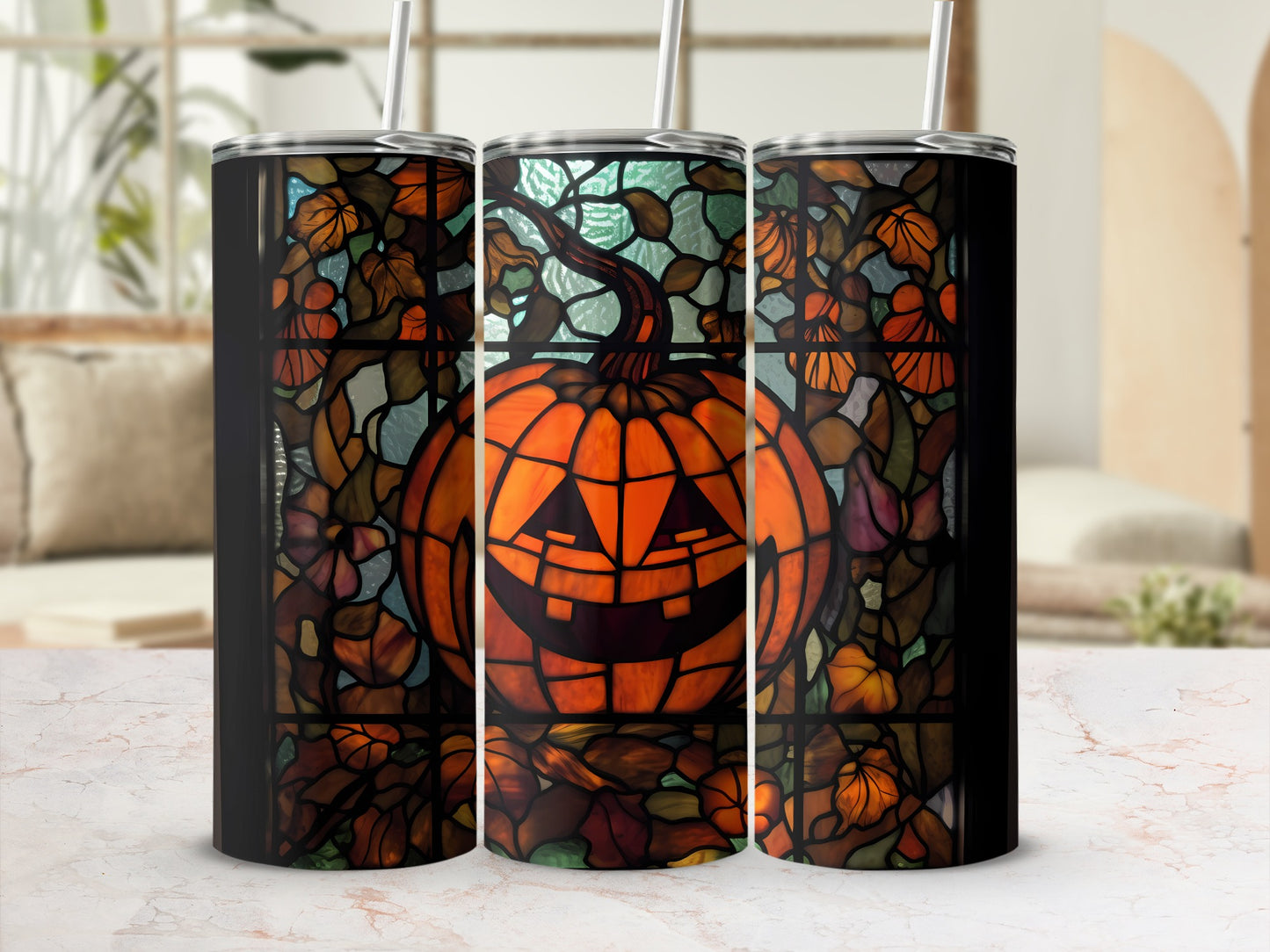 Stained glass pumpkin tumbler with autumn leaves and straw.