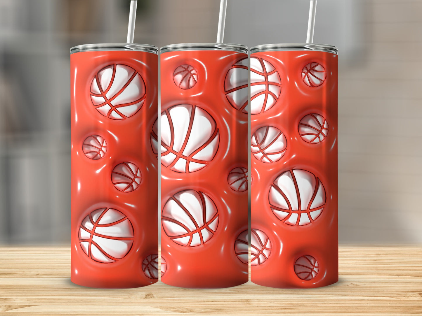 Three tall cylindrical tumblers with a repeating pattern of basketballs in recessed circles.