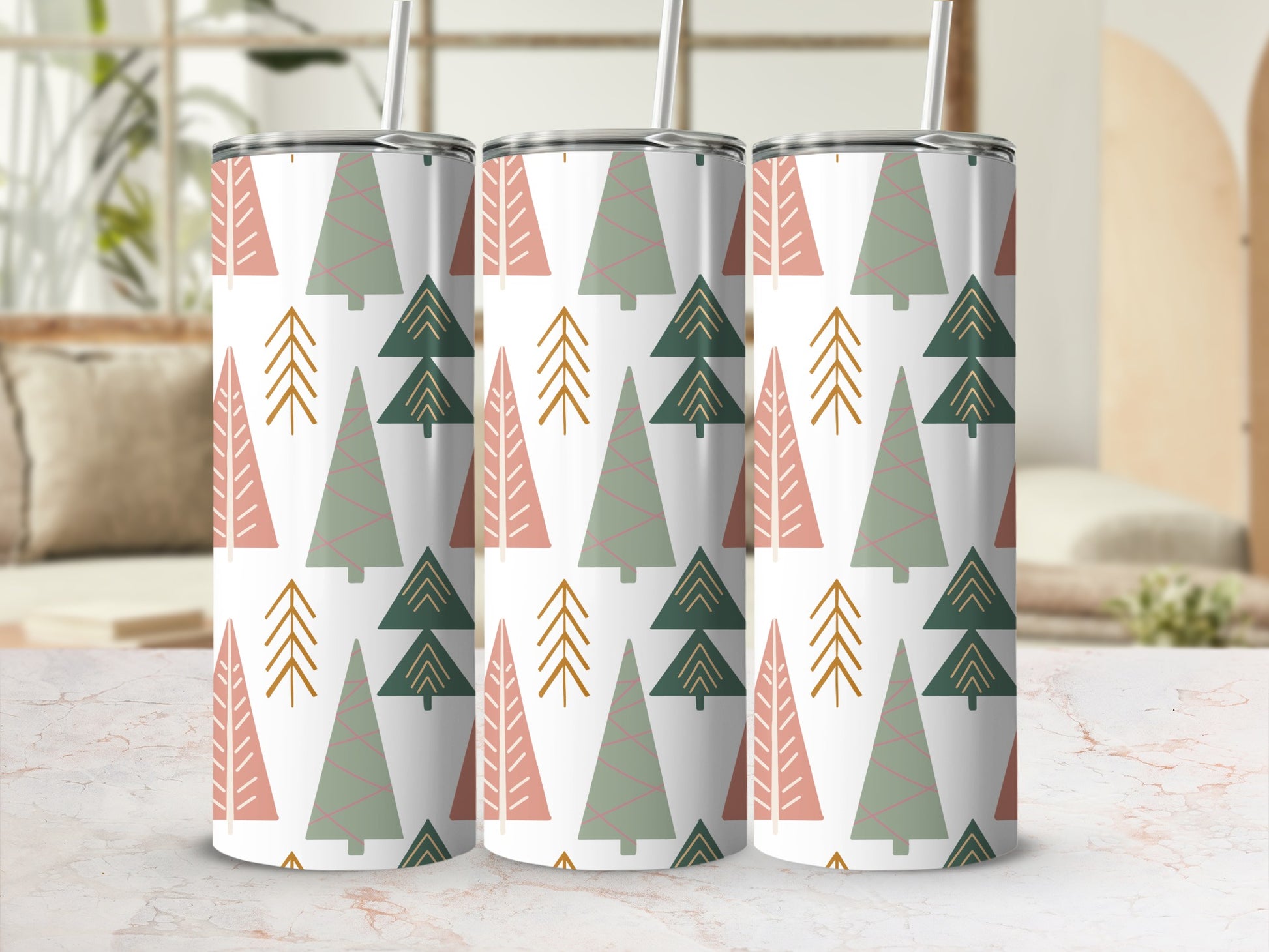 Three tumblers with a repeating pattern of pine trees in green, pink, and gold.