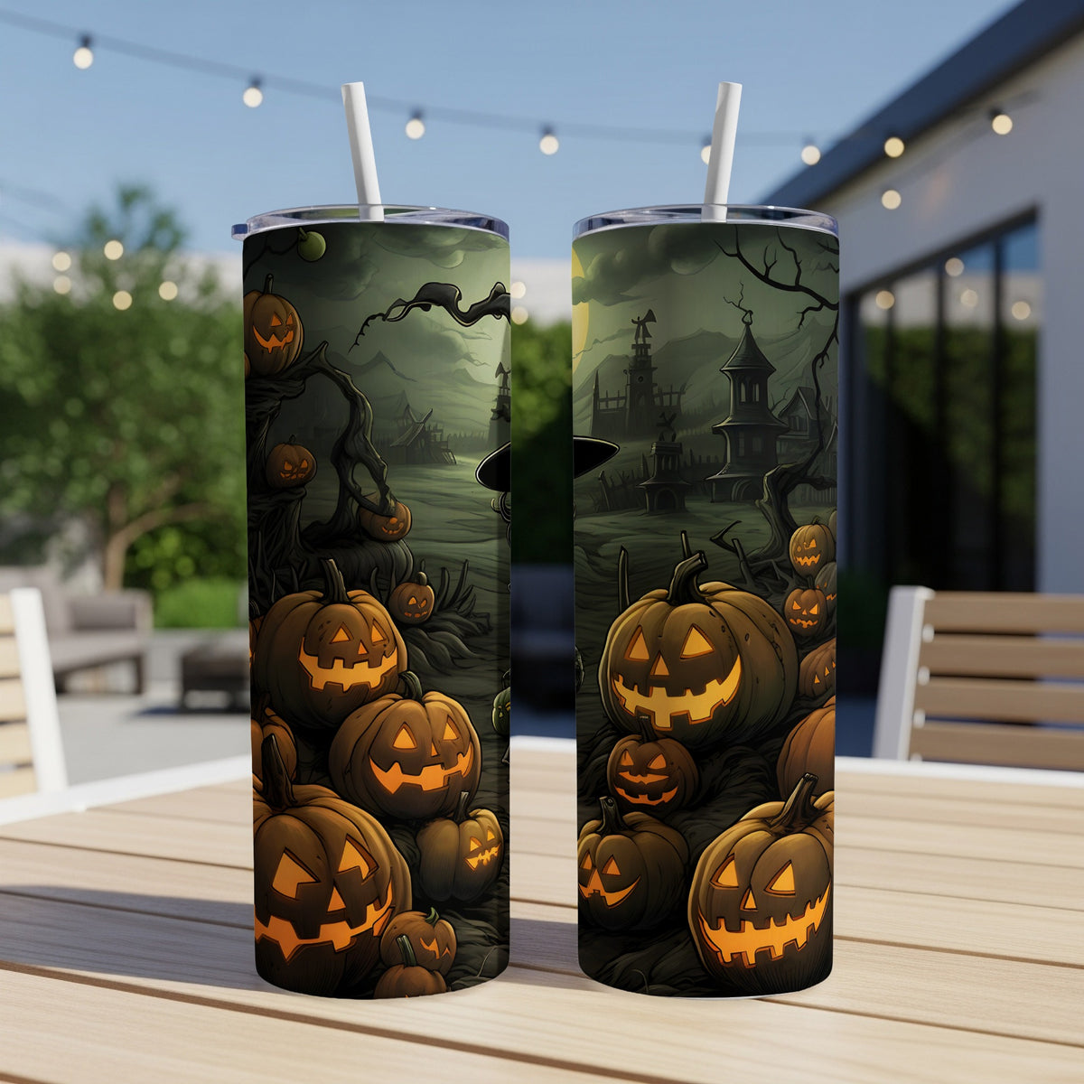 Two tumblers with a spooky Halloween scene of jack-o'-lanterns and haunted houses.