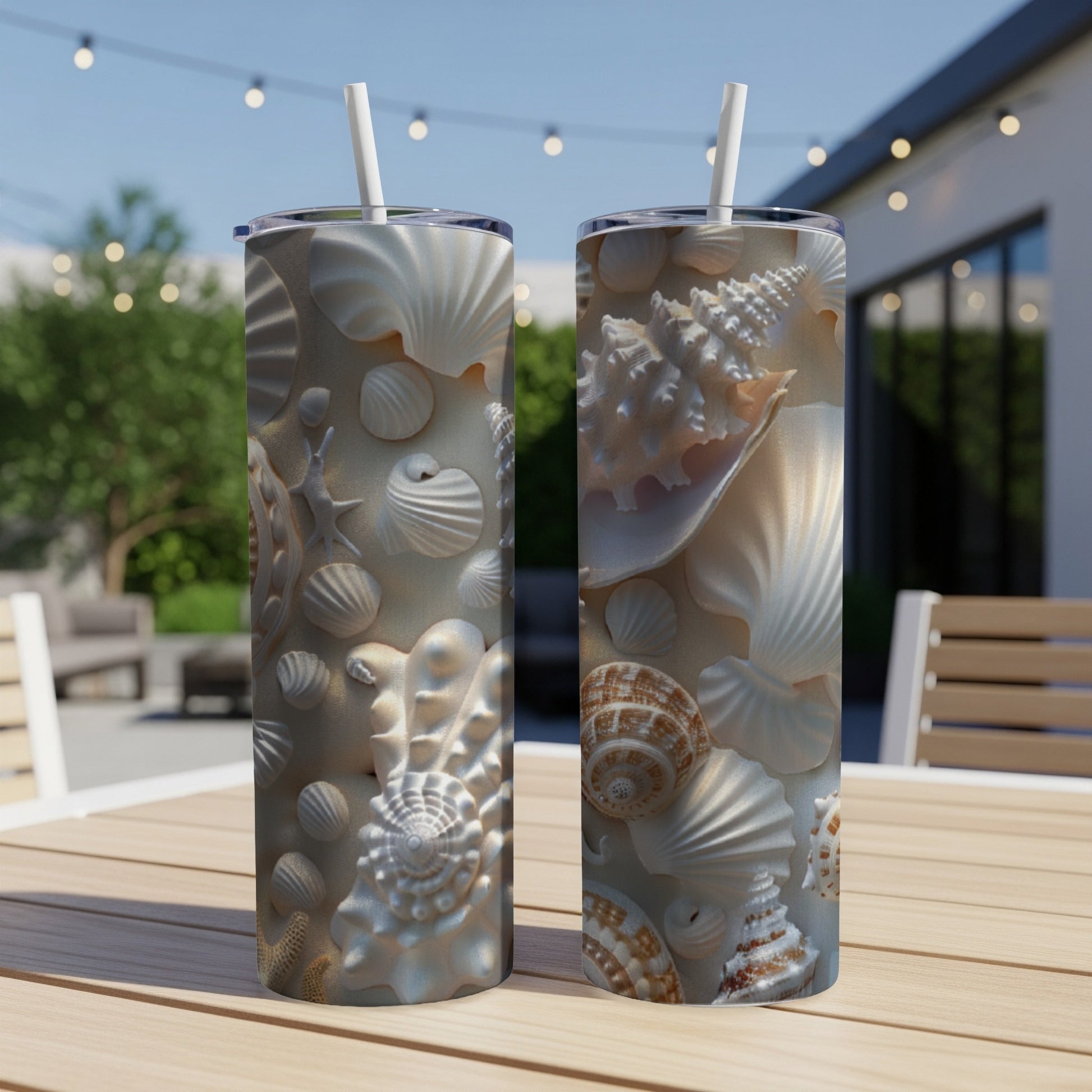 Two tall, insulated tumblers featuring a detailed seashell pattern.