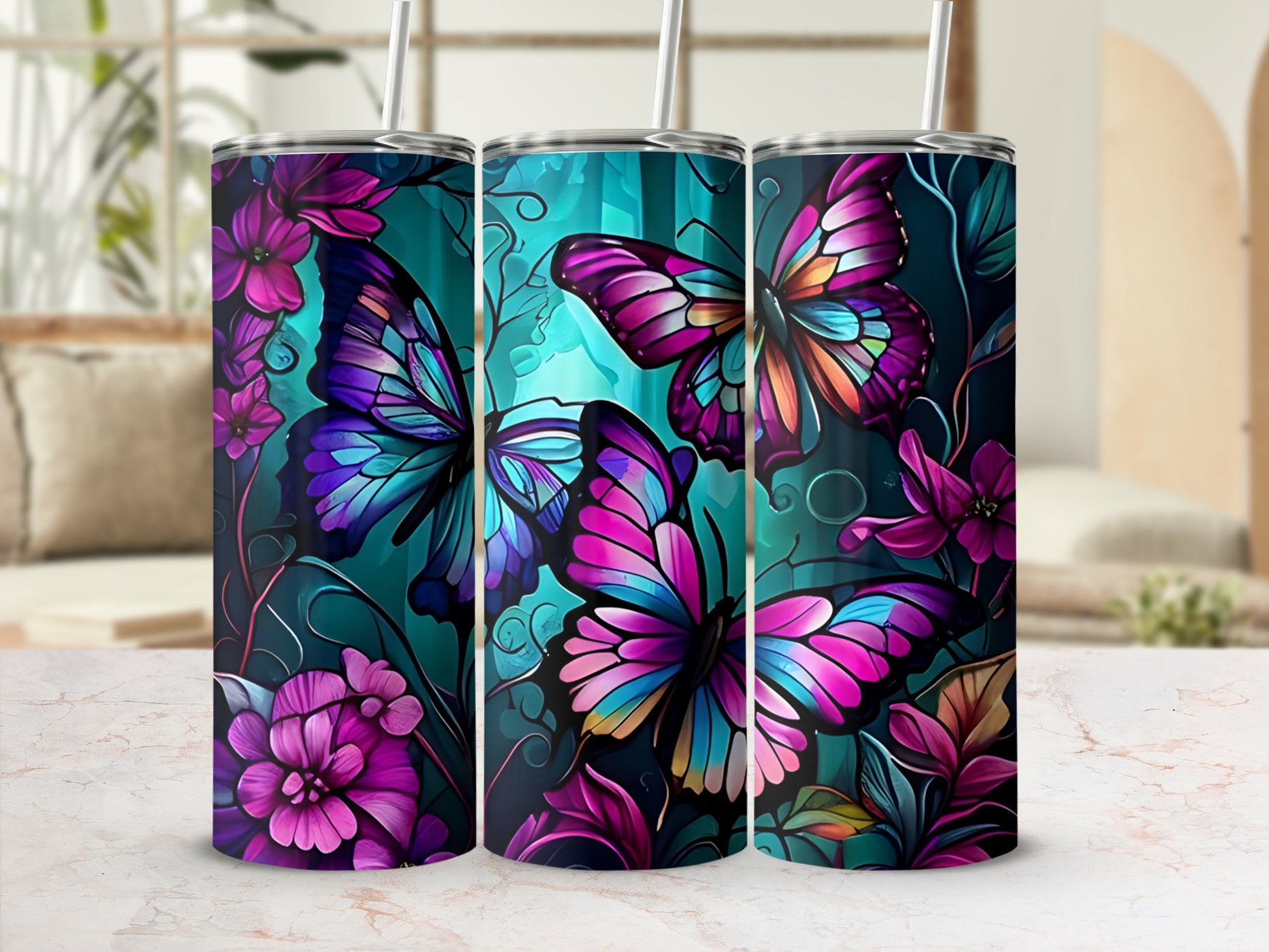 Three tumblers with colorful butterfly and floral designs on a teal background.
