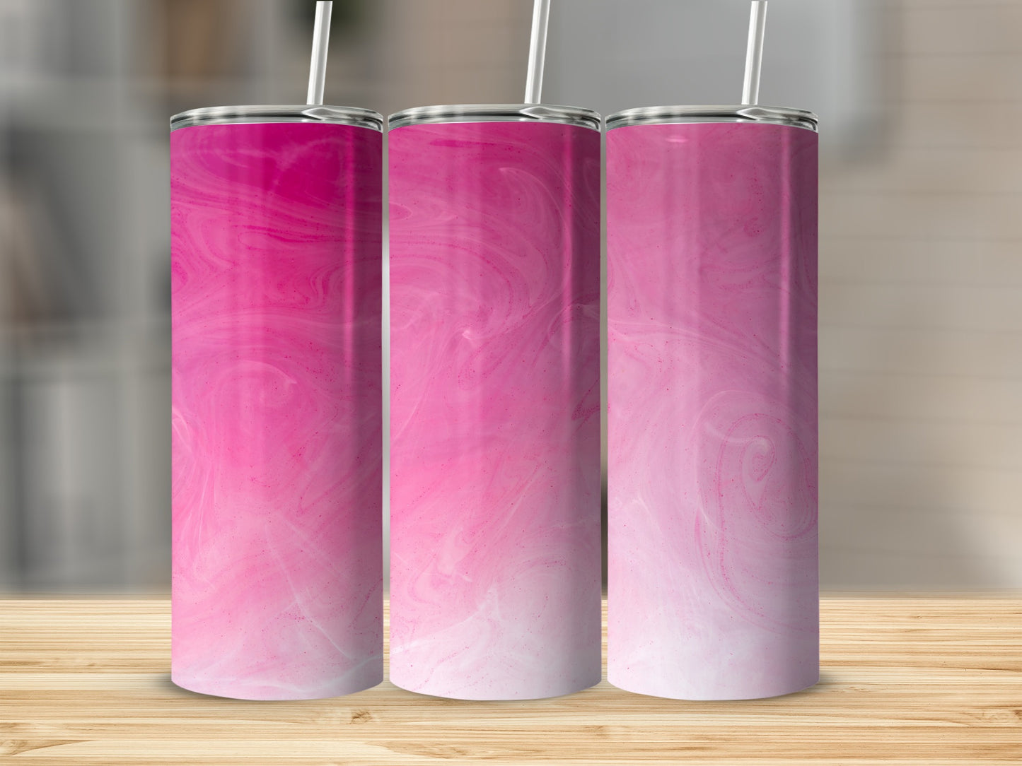 Three tall tumblers with pink and white marbled design and white straws.
