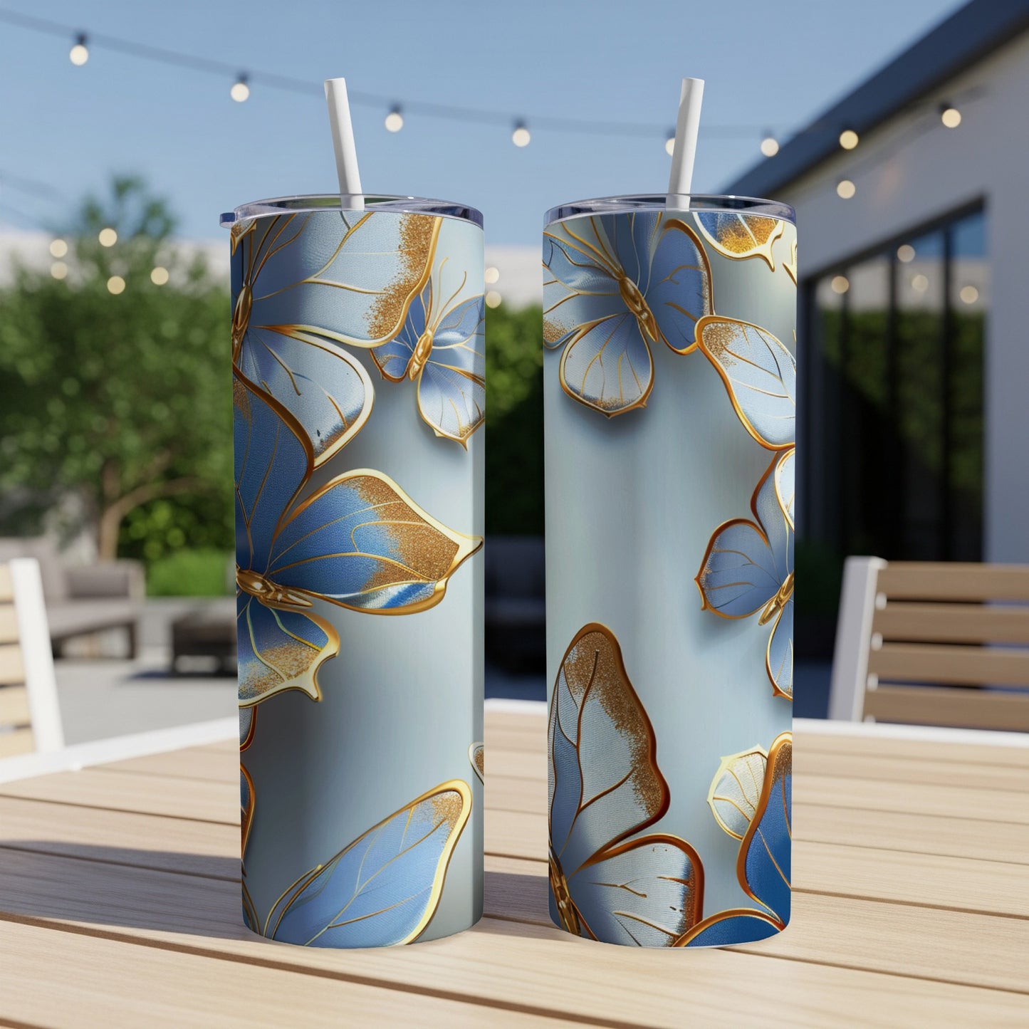 Two tall, slender tumblers with a blue butterfly design and gold accents.