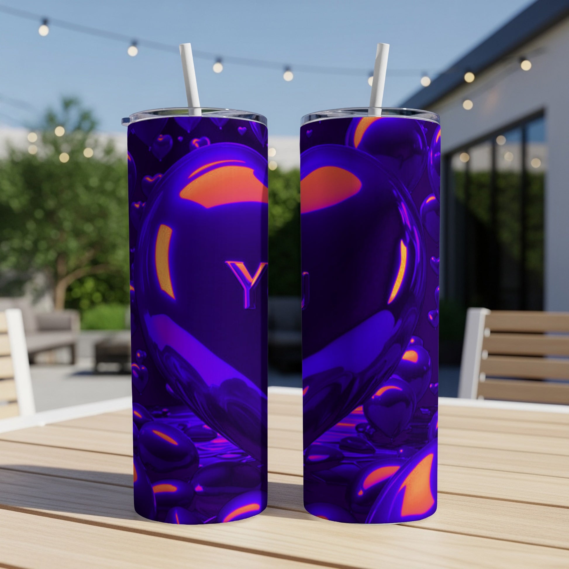 Purple heart-shaped tumbler with a straw, sitting on a table outdoors.
