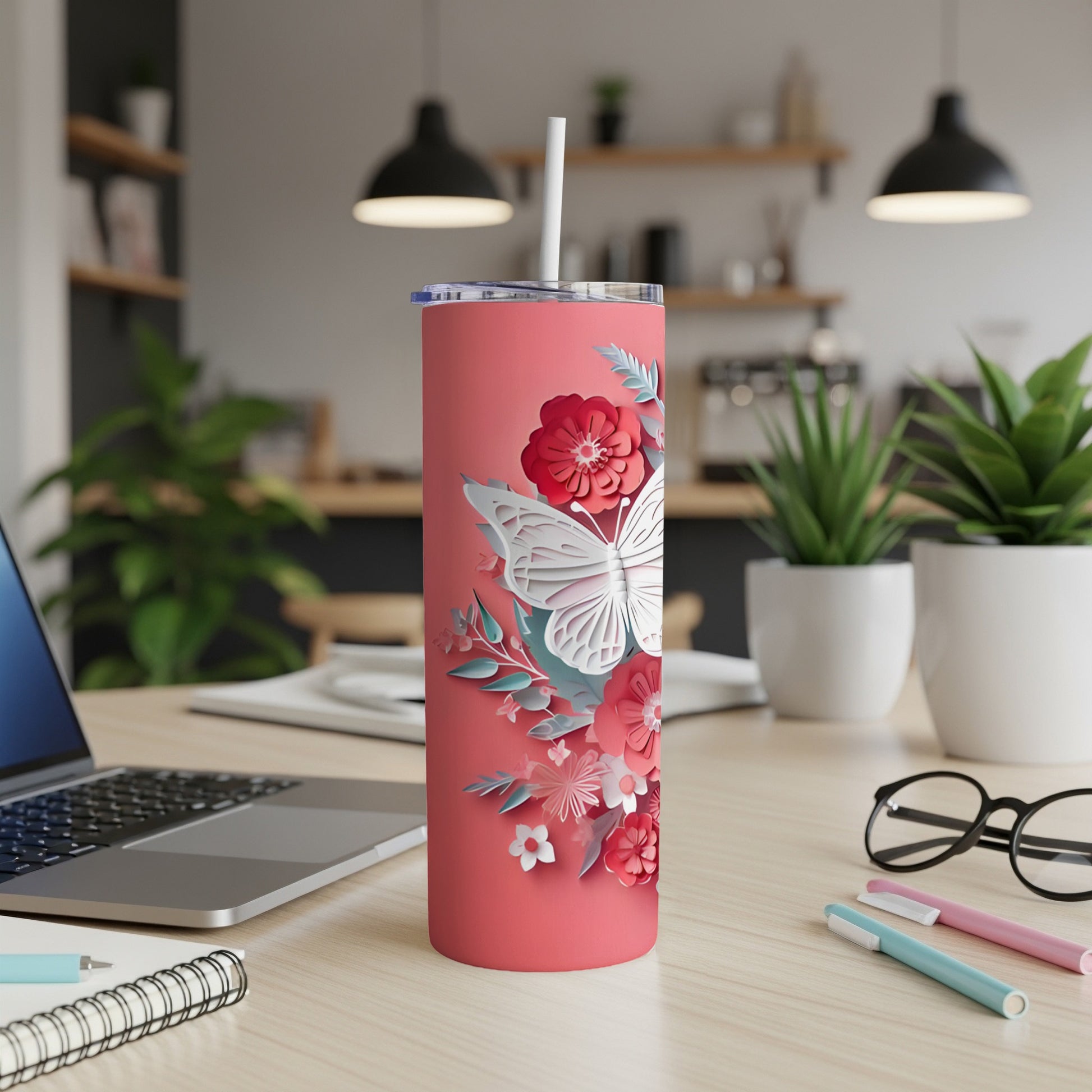 Coral tumbler with butterfly and floral papercraft design.