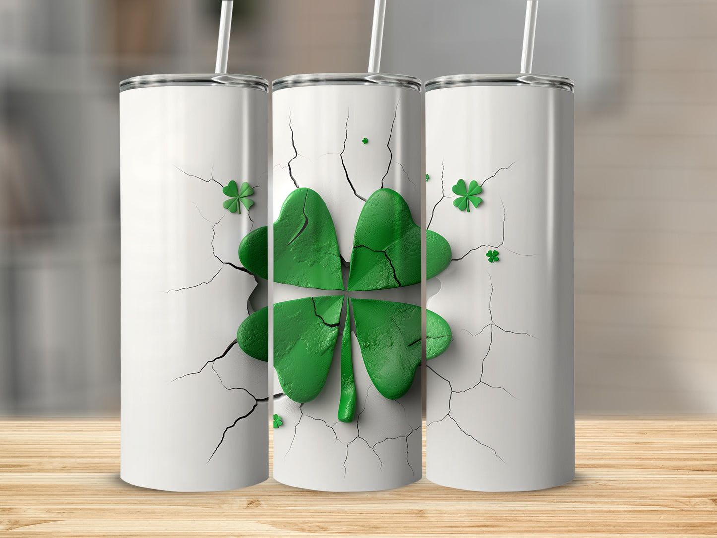 Three white tumblers with green clover designs and cracked earth texture.