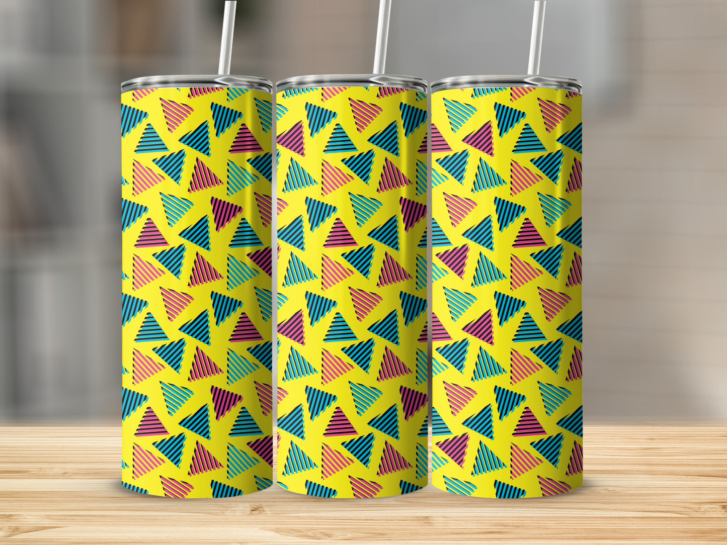 Three tumblers with a yellow background and a repeating pattern of striped triangles.