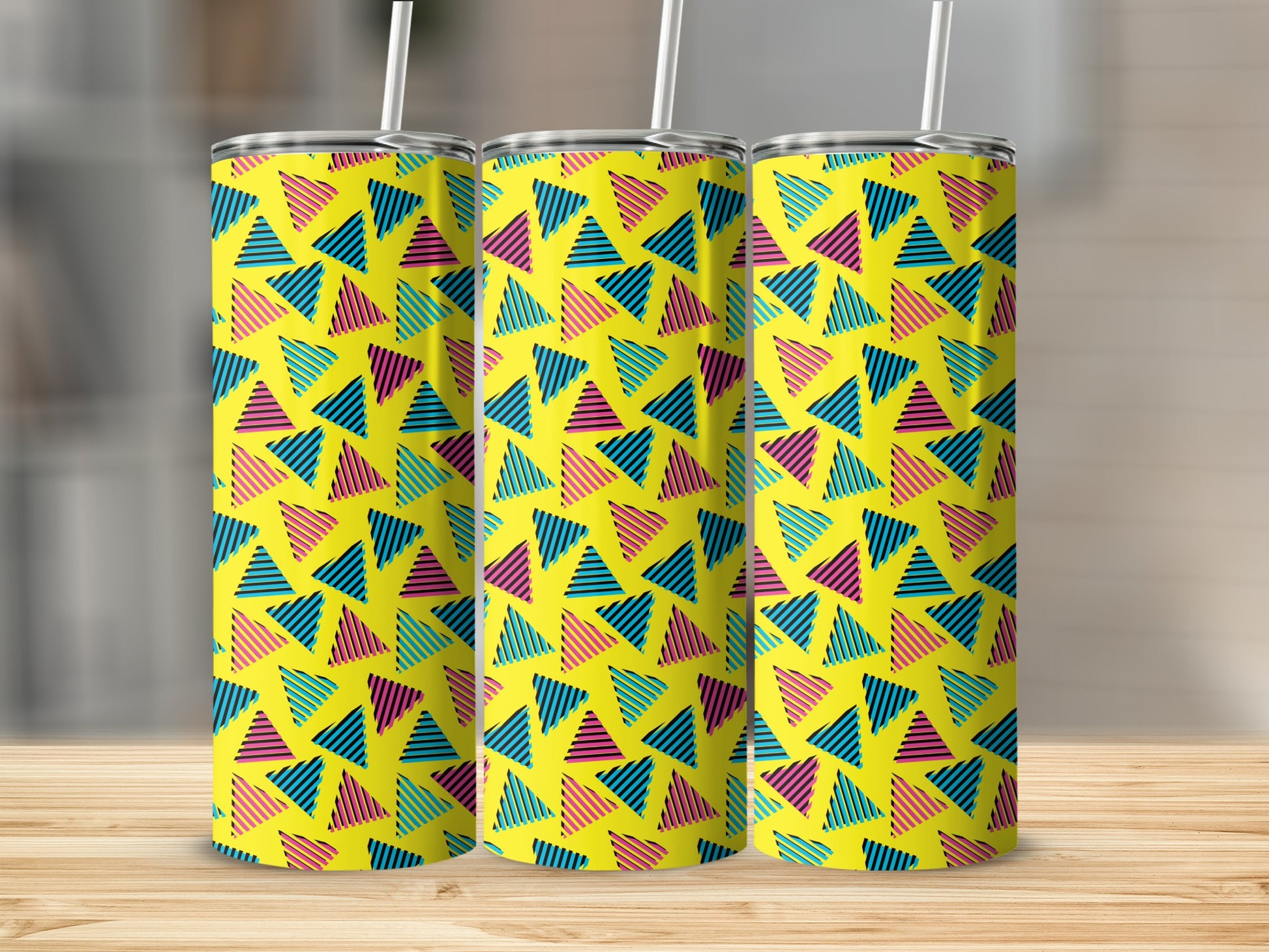 Three tumblers with a yellow background and a repeating pattern of striped triangles.