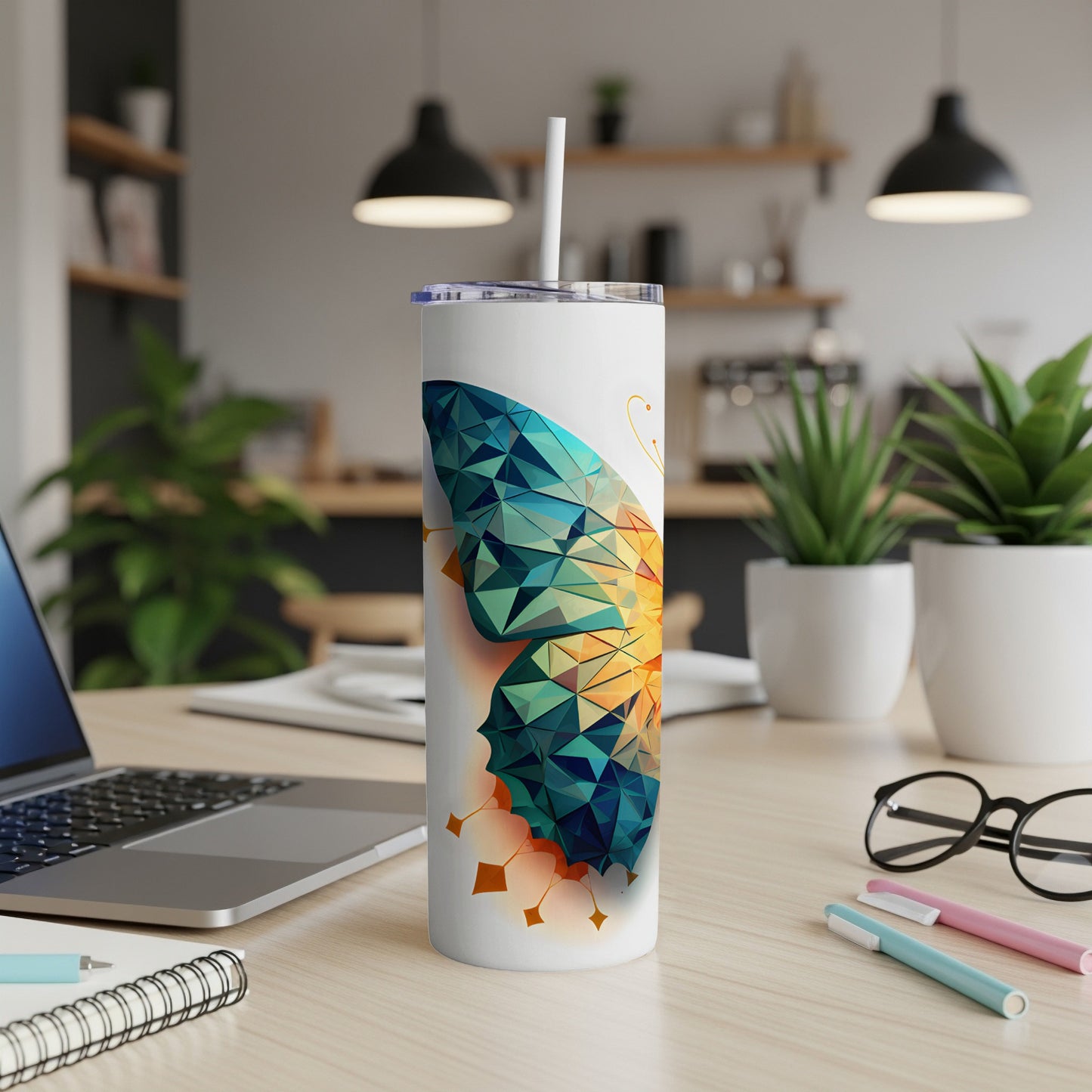 Tumbler with a geometric butterfly design and a white straw.