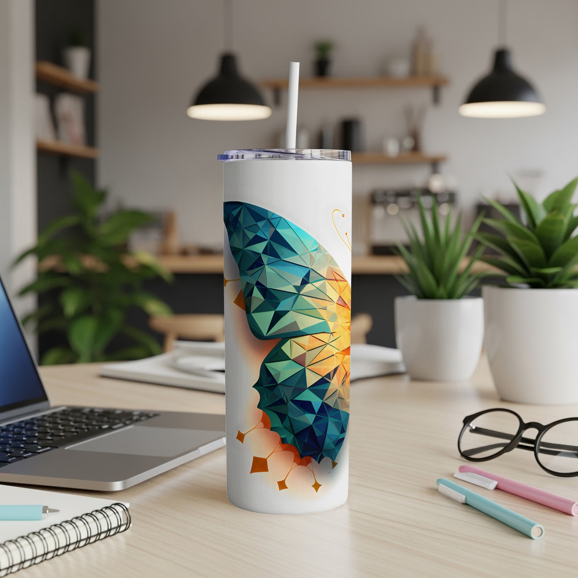 Tumbler with a geometric butterfly design and a white straw.